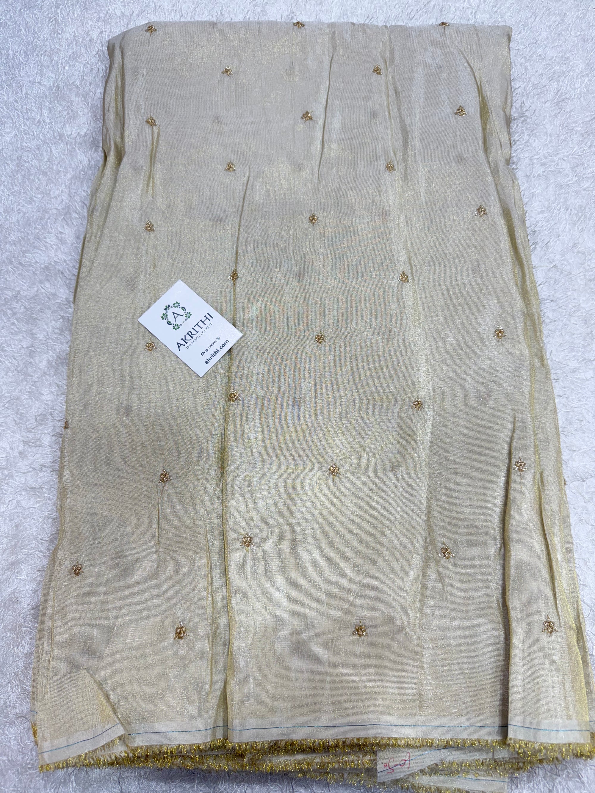 Sequins on dyeable tissue fabric