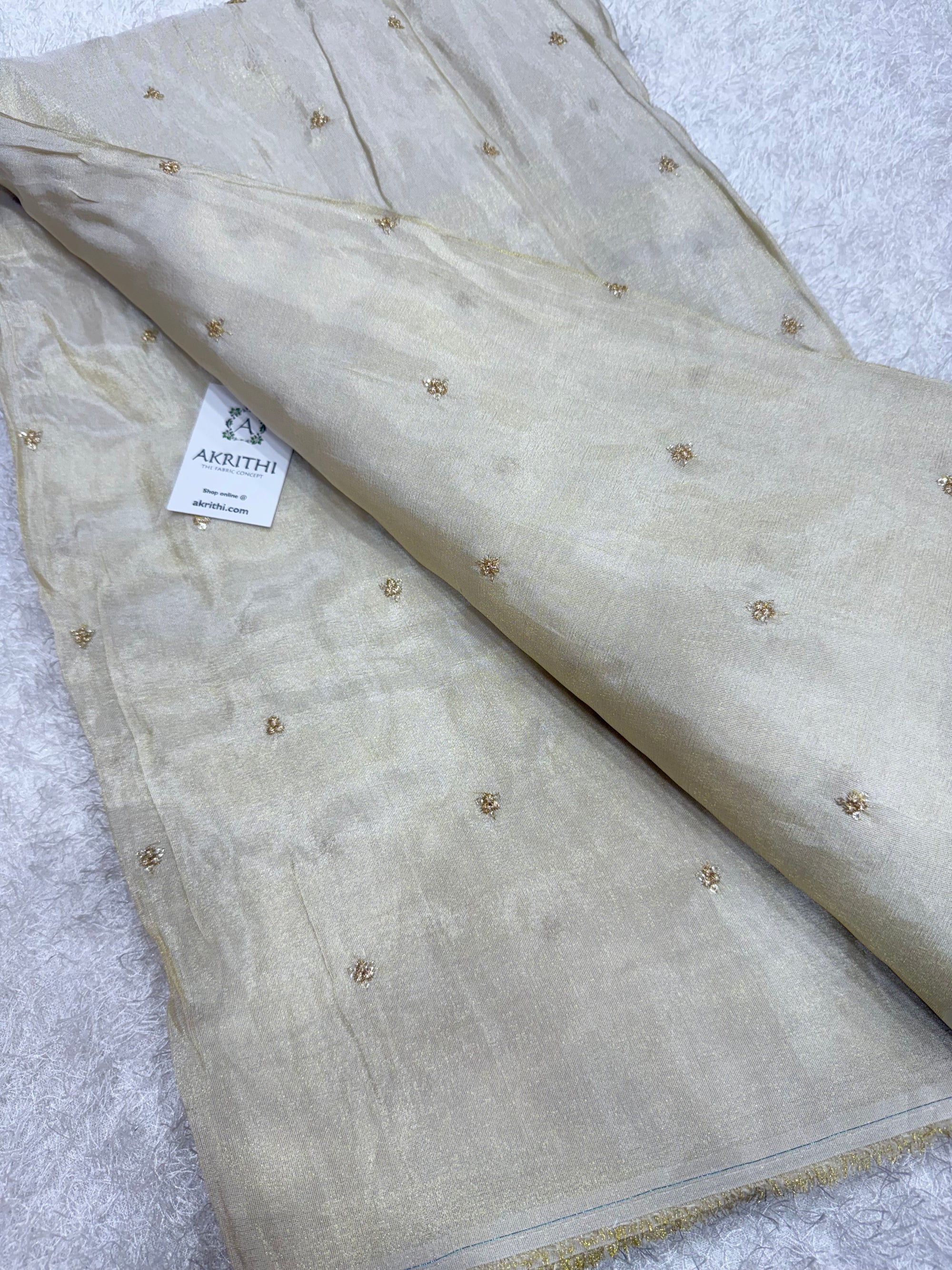 Sequins on dyeable tissue fabric