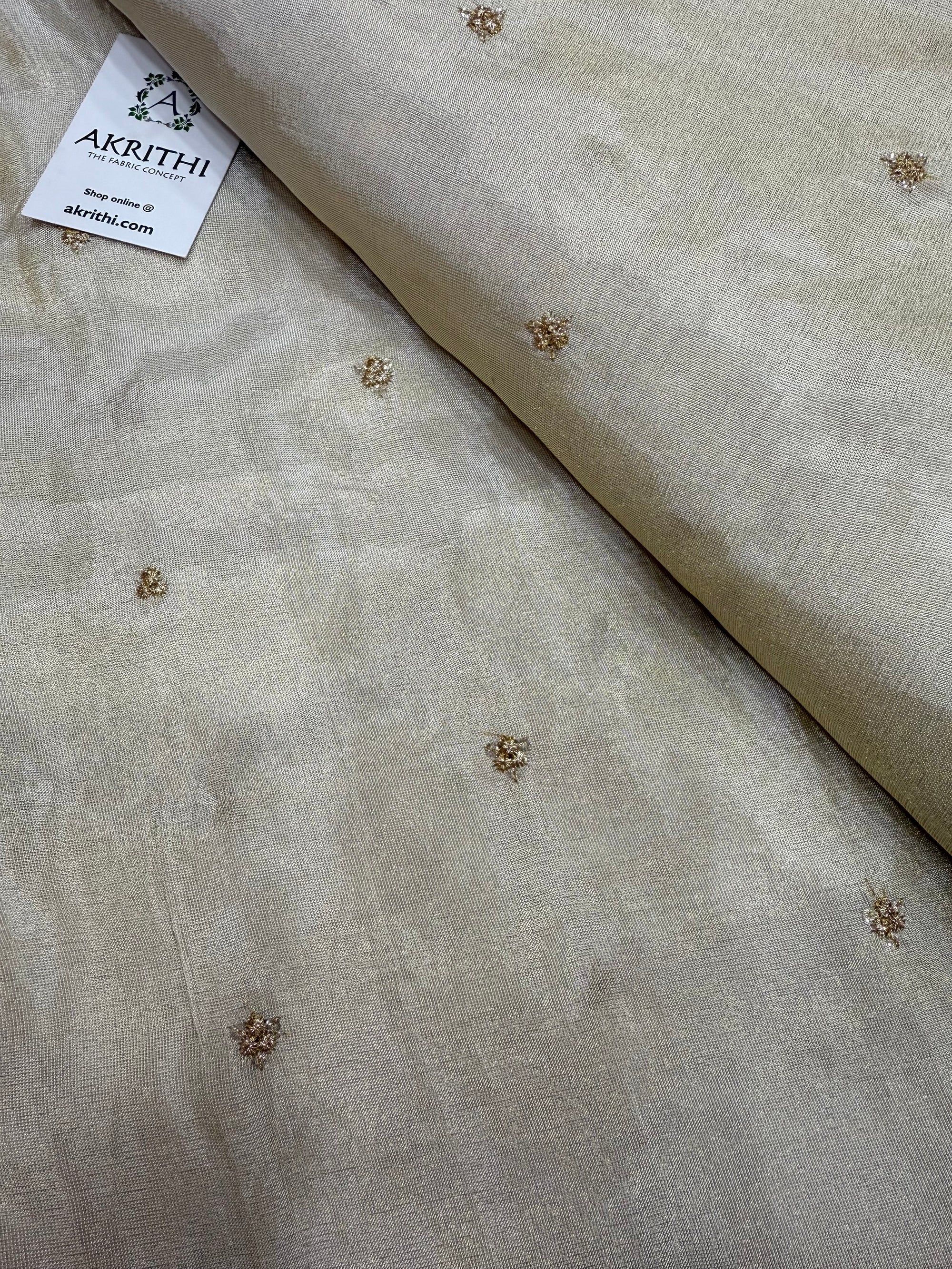 Sequins on dyeable tissue fabric