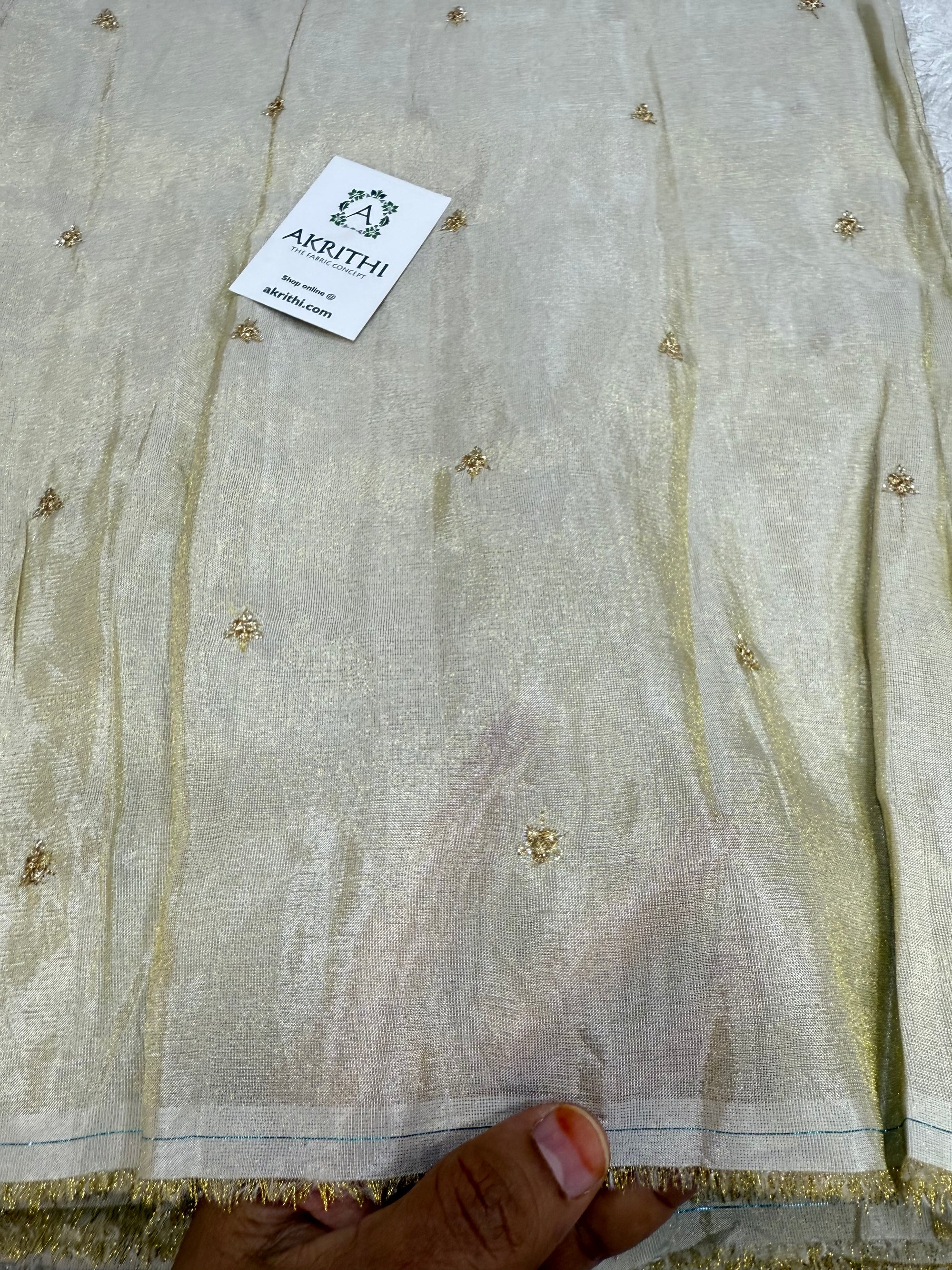 Sequins on dyeable tissue fabric