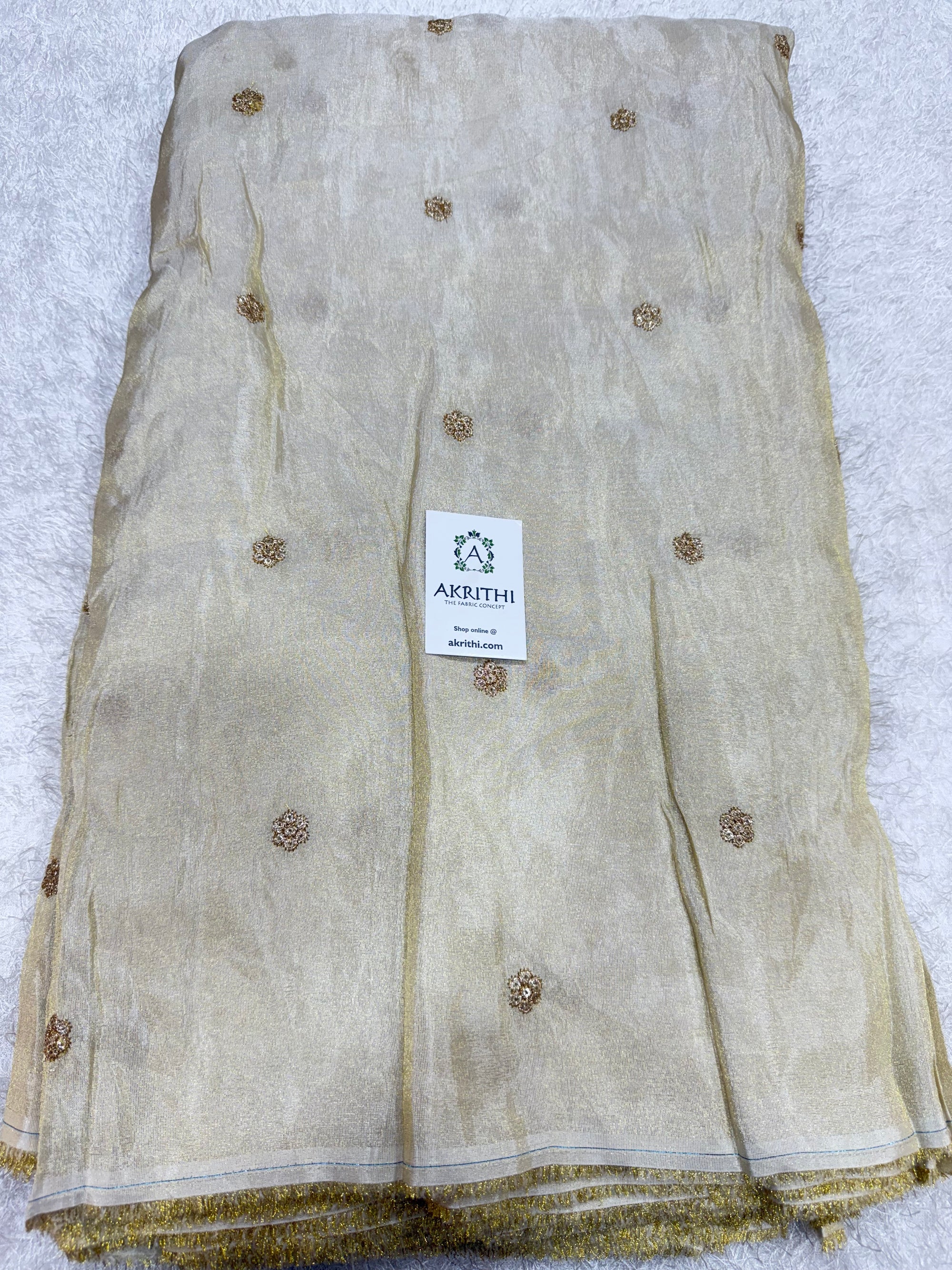 Sequins on dyeable tissue fabric