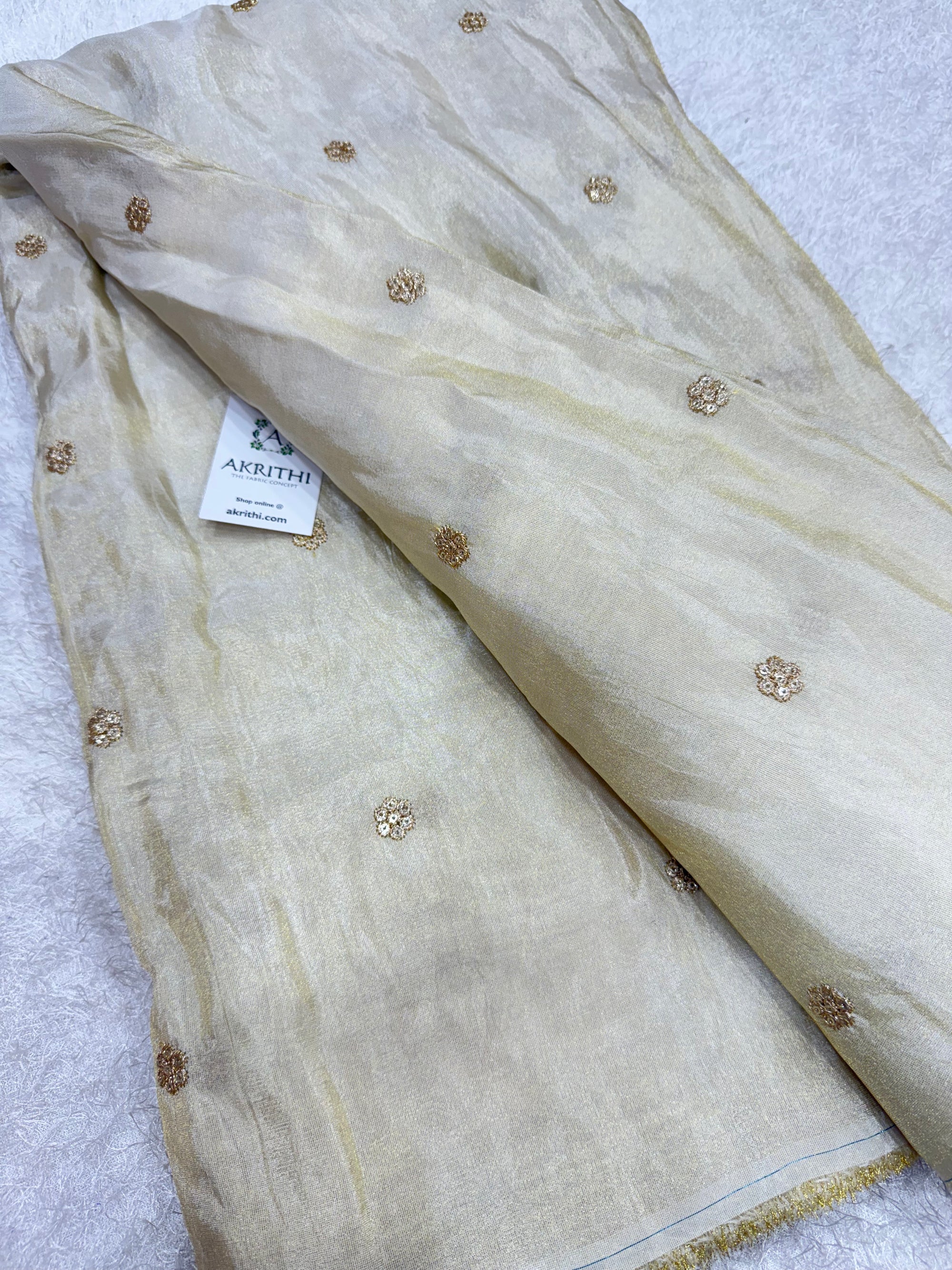 Sequins on dyeable tissue fabric