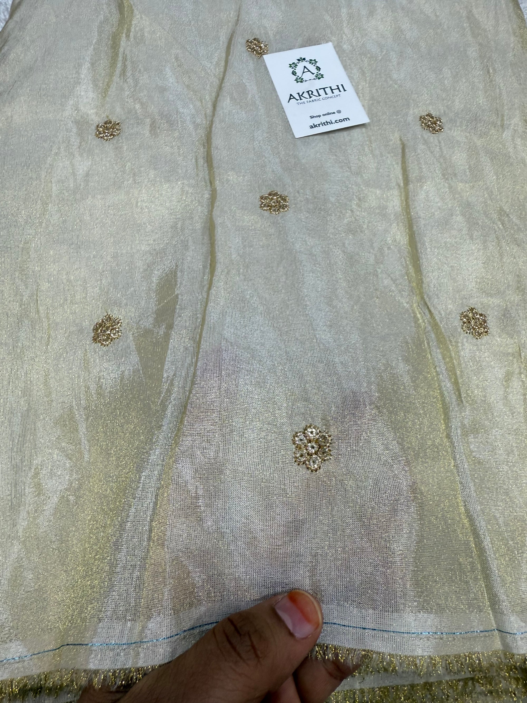 Sequins on dyeable tissue fabric