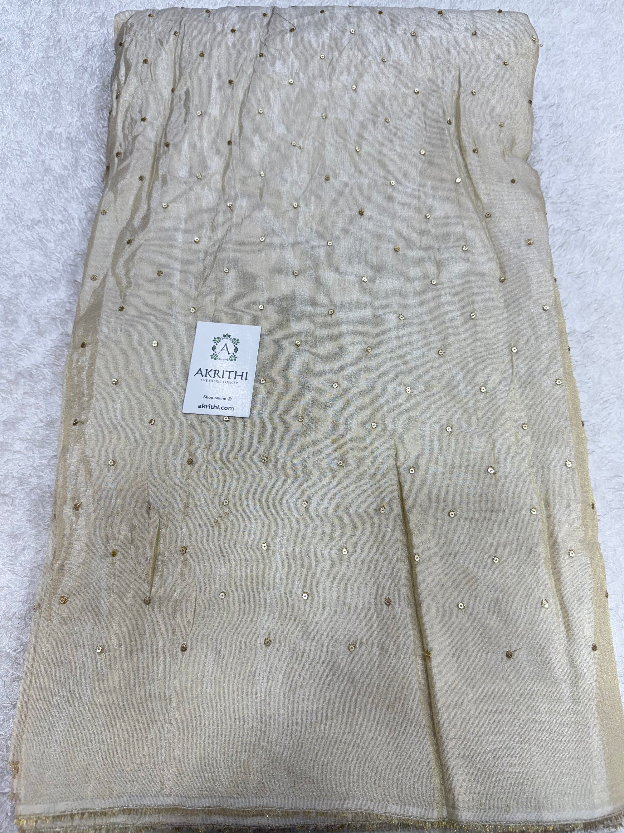 Sequins on dyeable tissue fabric