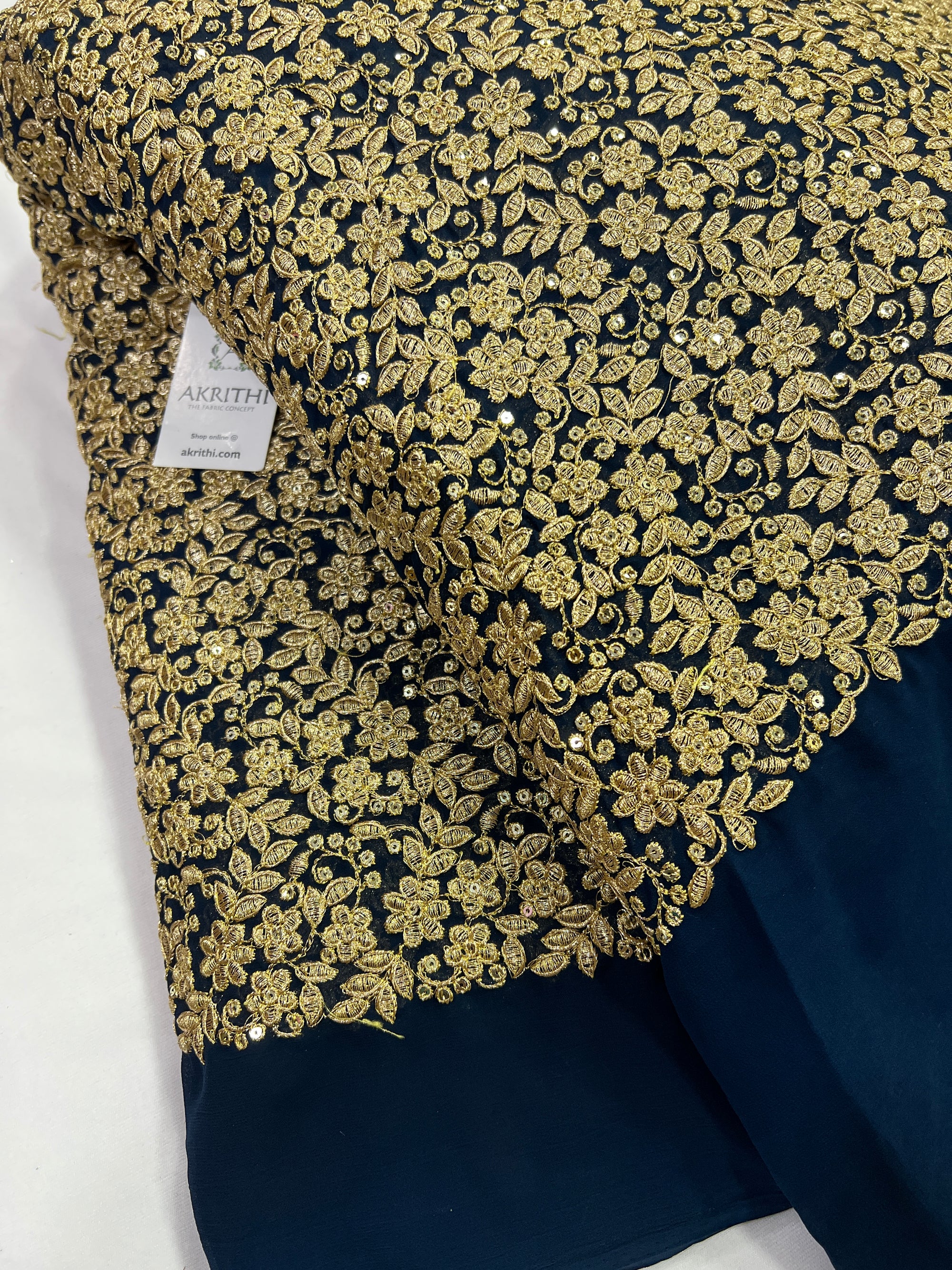 Embroidery on peacock blue georgette fabric