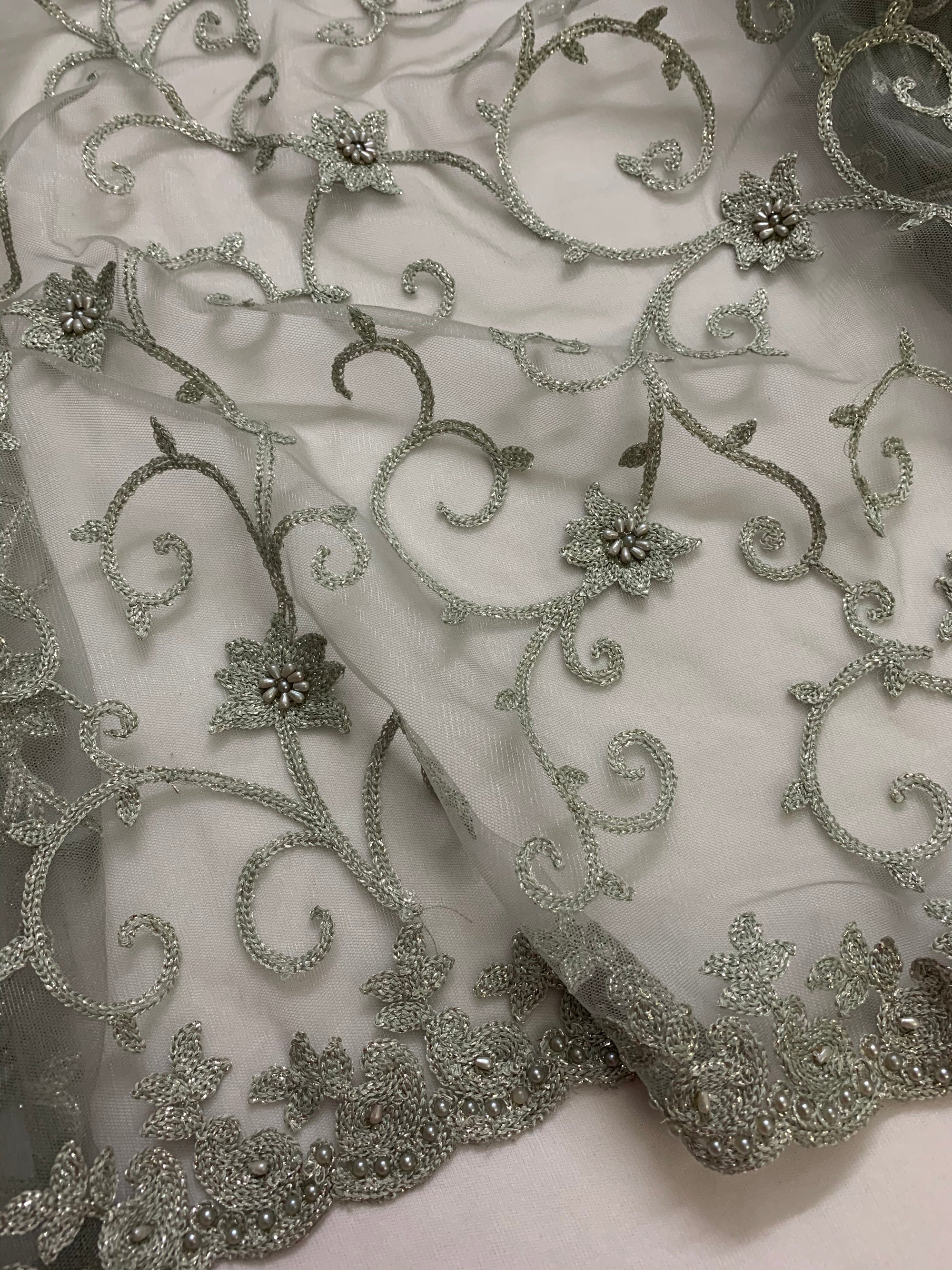 Embroidery on grey net fabric