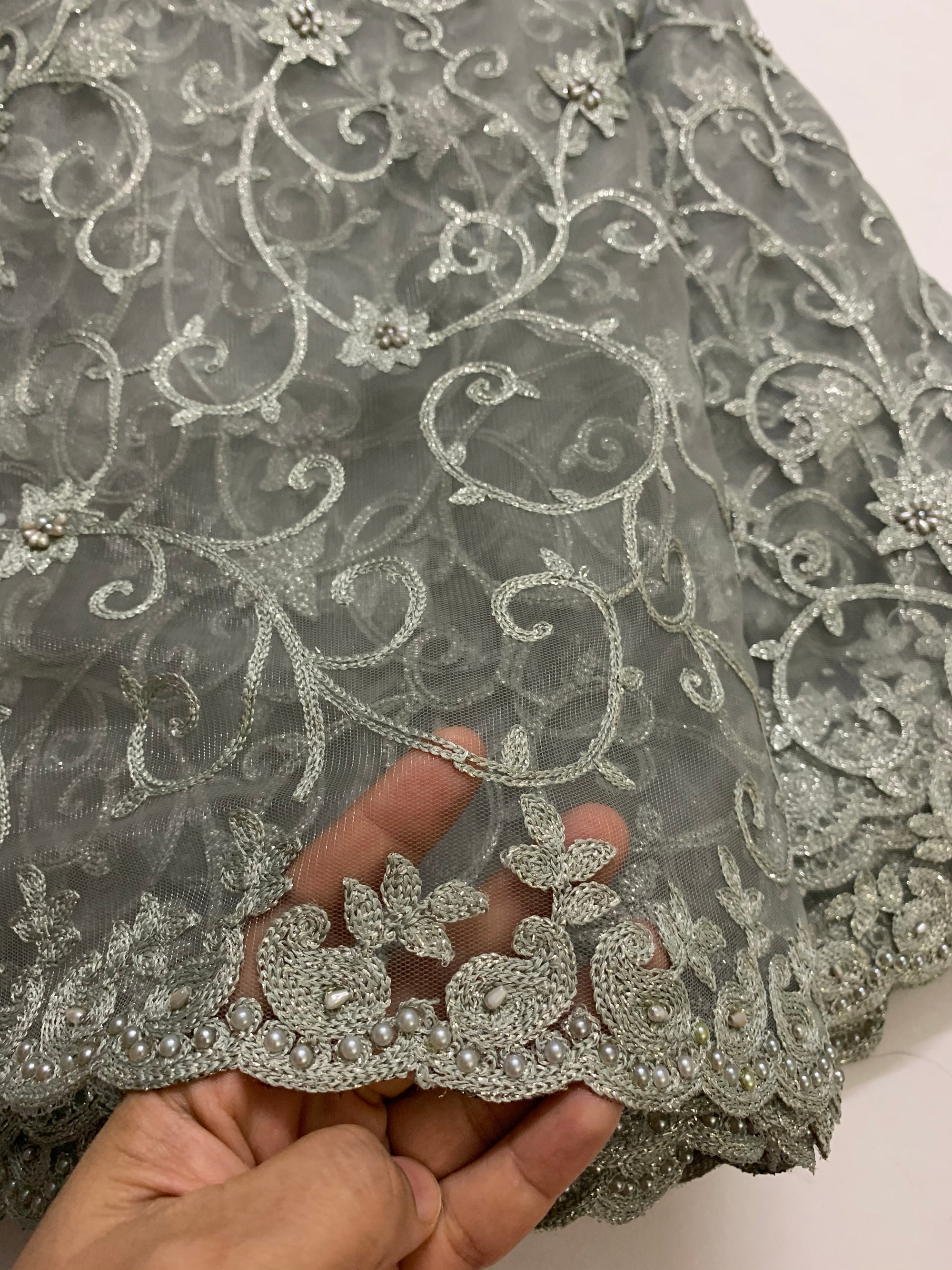 Embroidery on grey net fabric