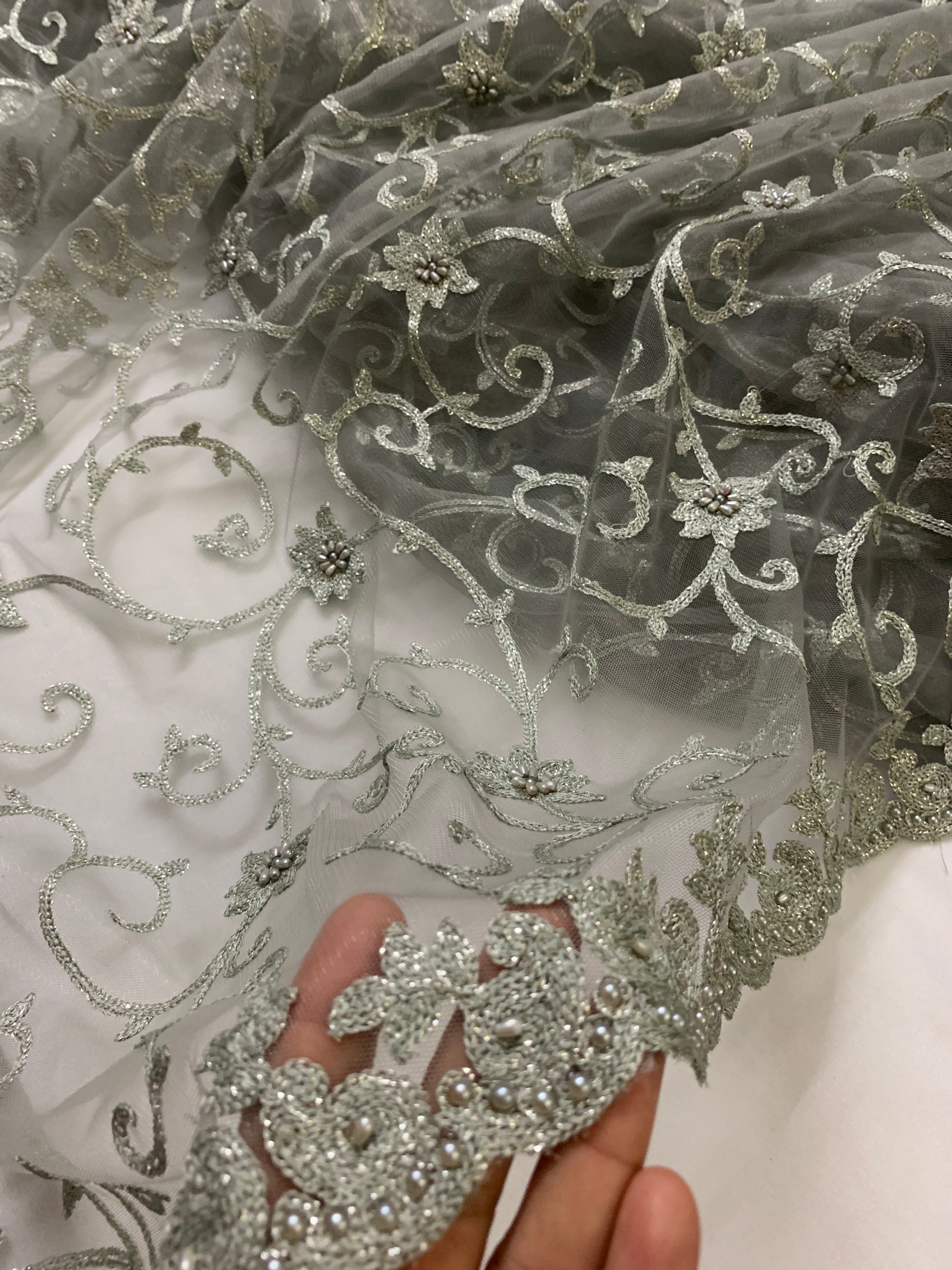 Embroidery on grey net fabric