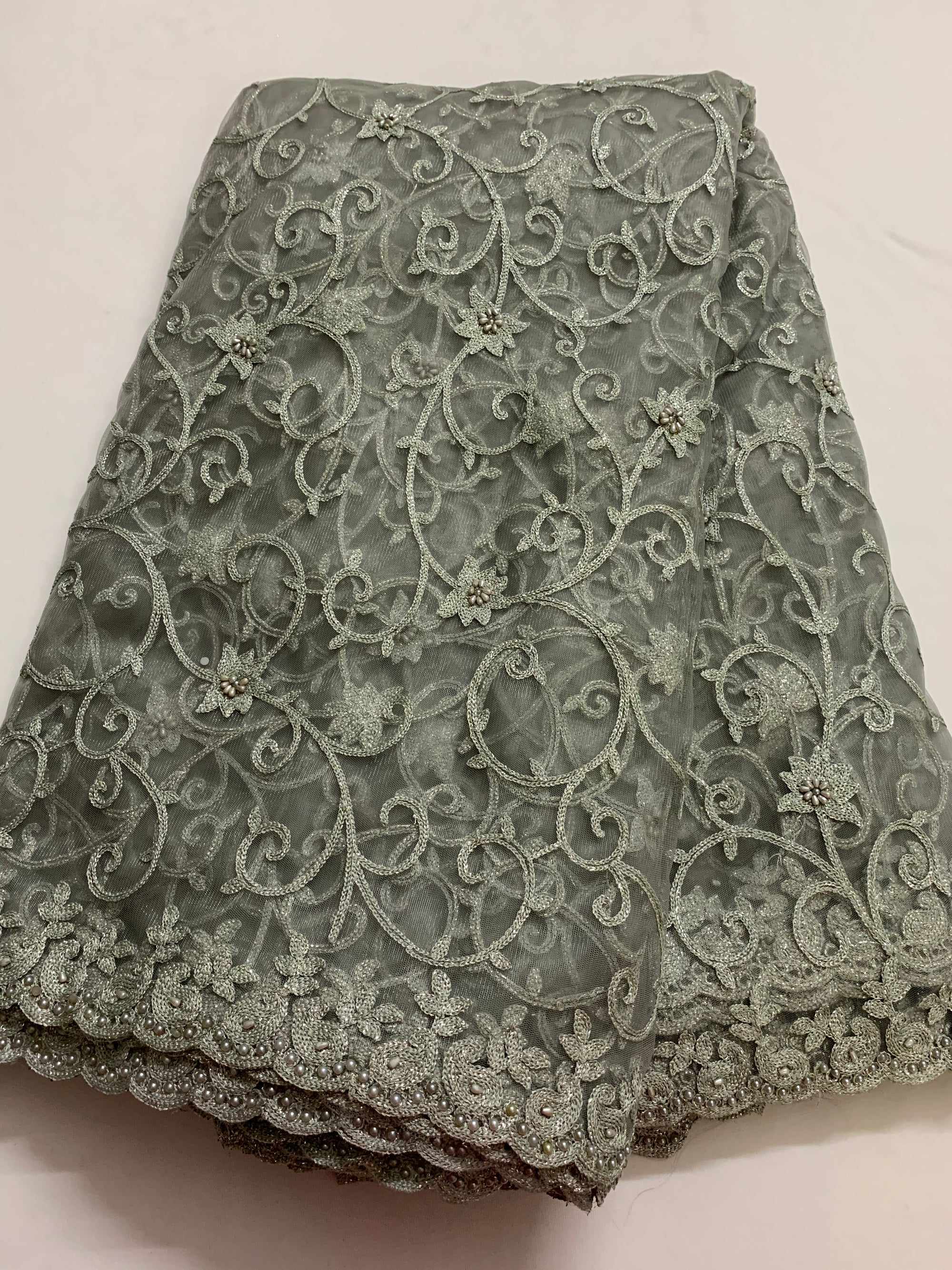 Embroidery on grey net fabric