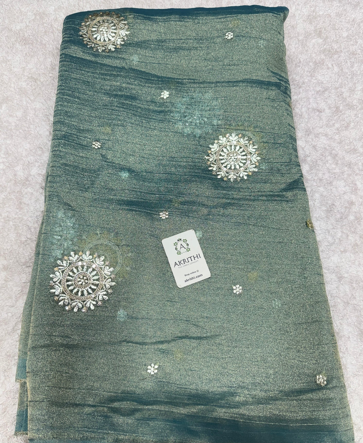 Embroidered crushed tissue fabric