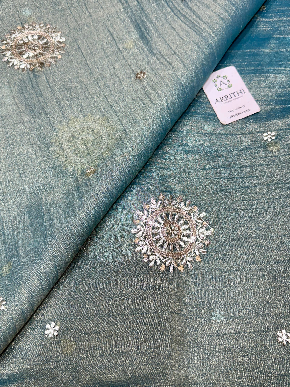 Embroidered crushed tissue fabric