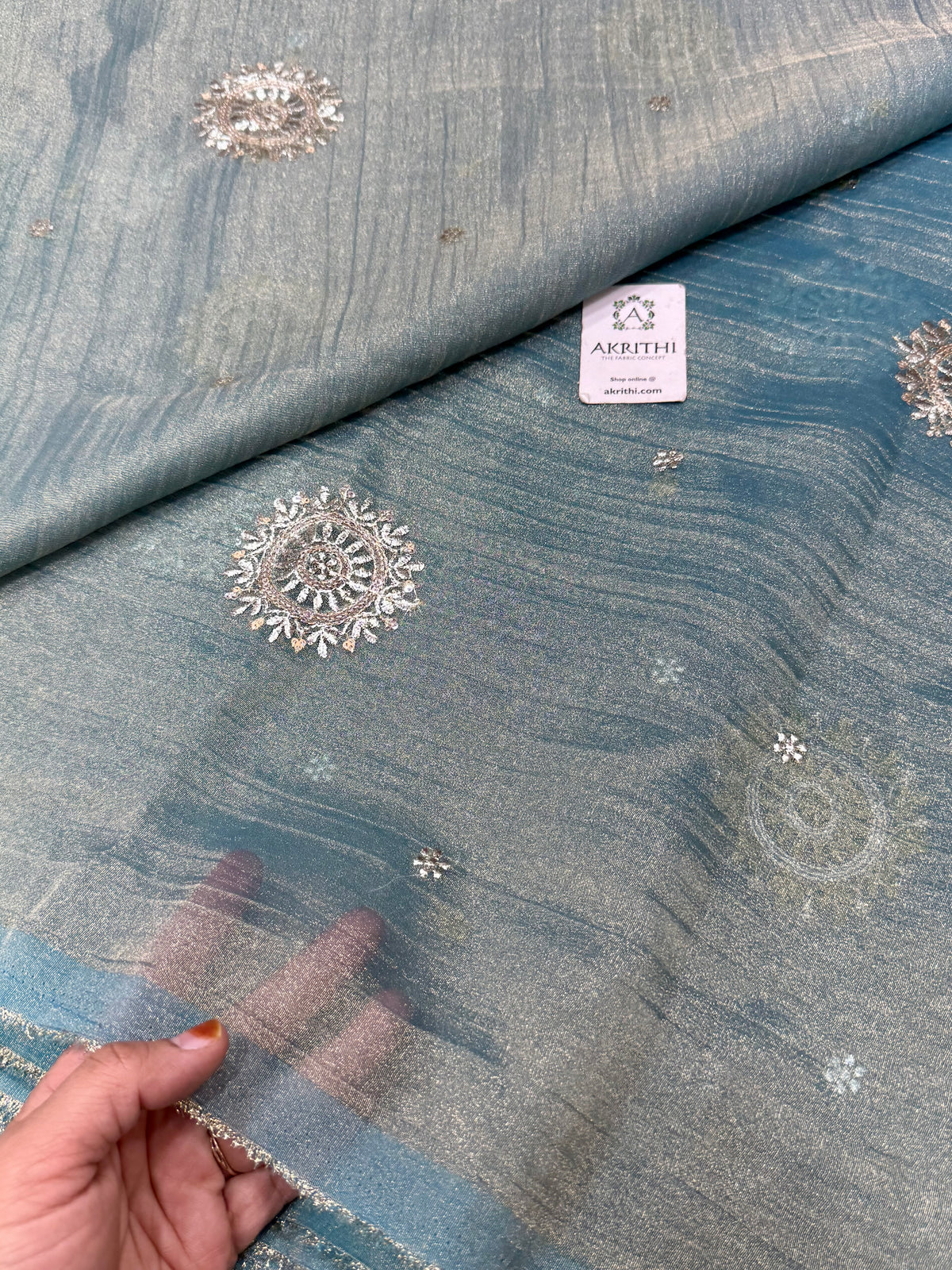 Embroidered crushed tissue fabric