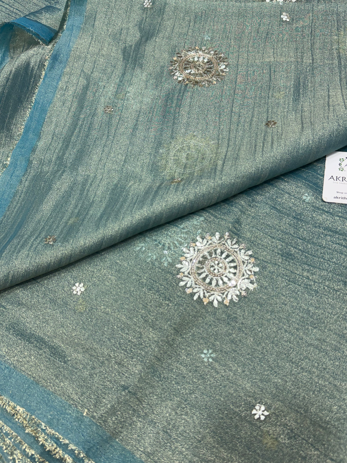 Embroidered crushed tissue fabric