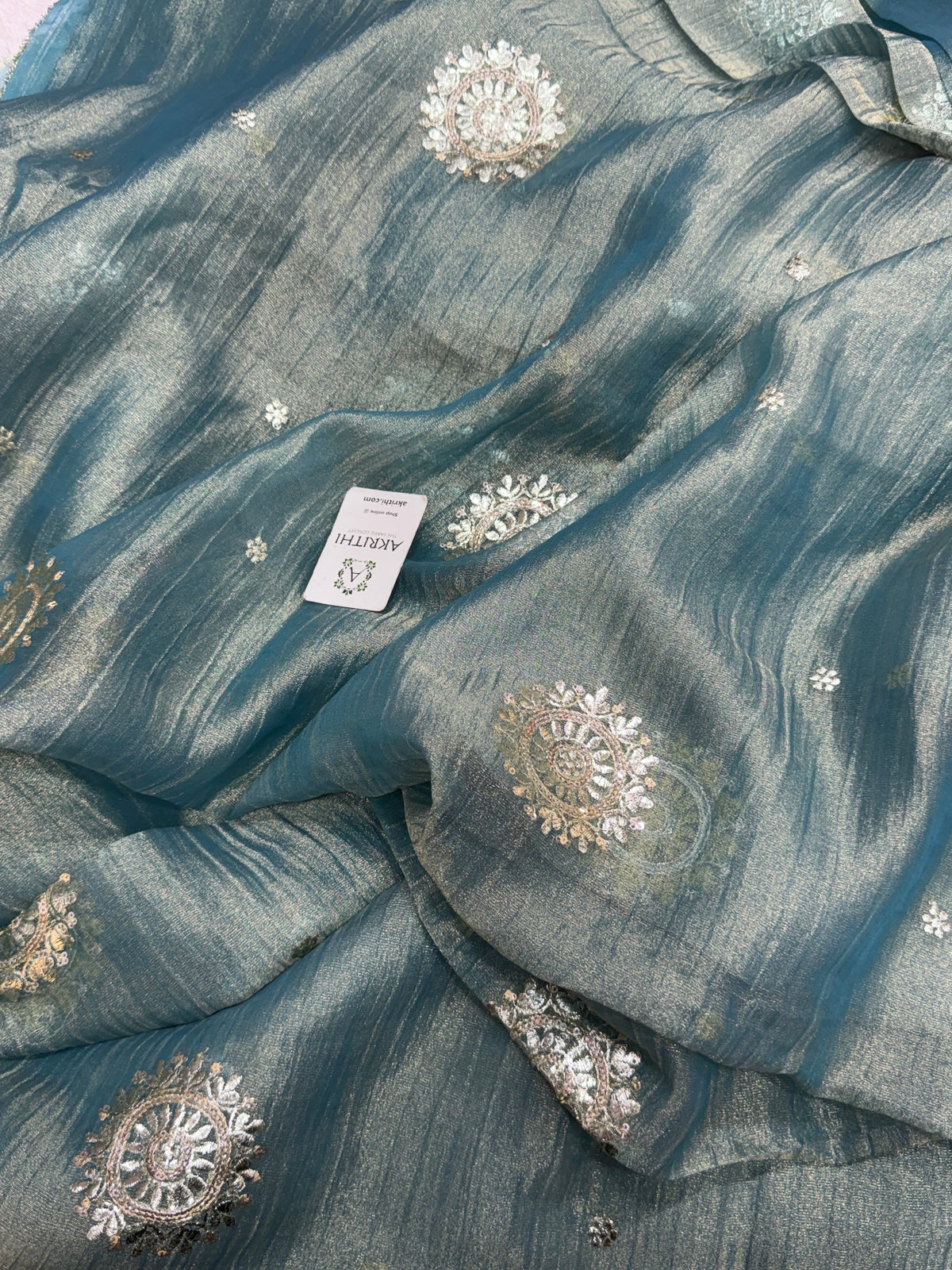 Embroidered crushed tissue fabric