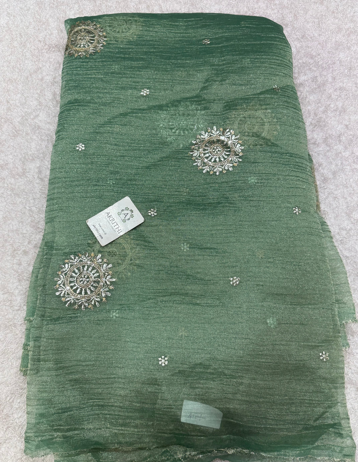 Embroidered crushed tissue fabric