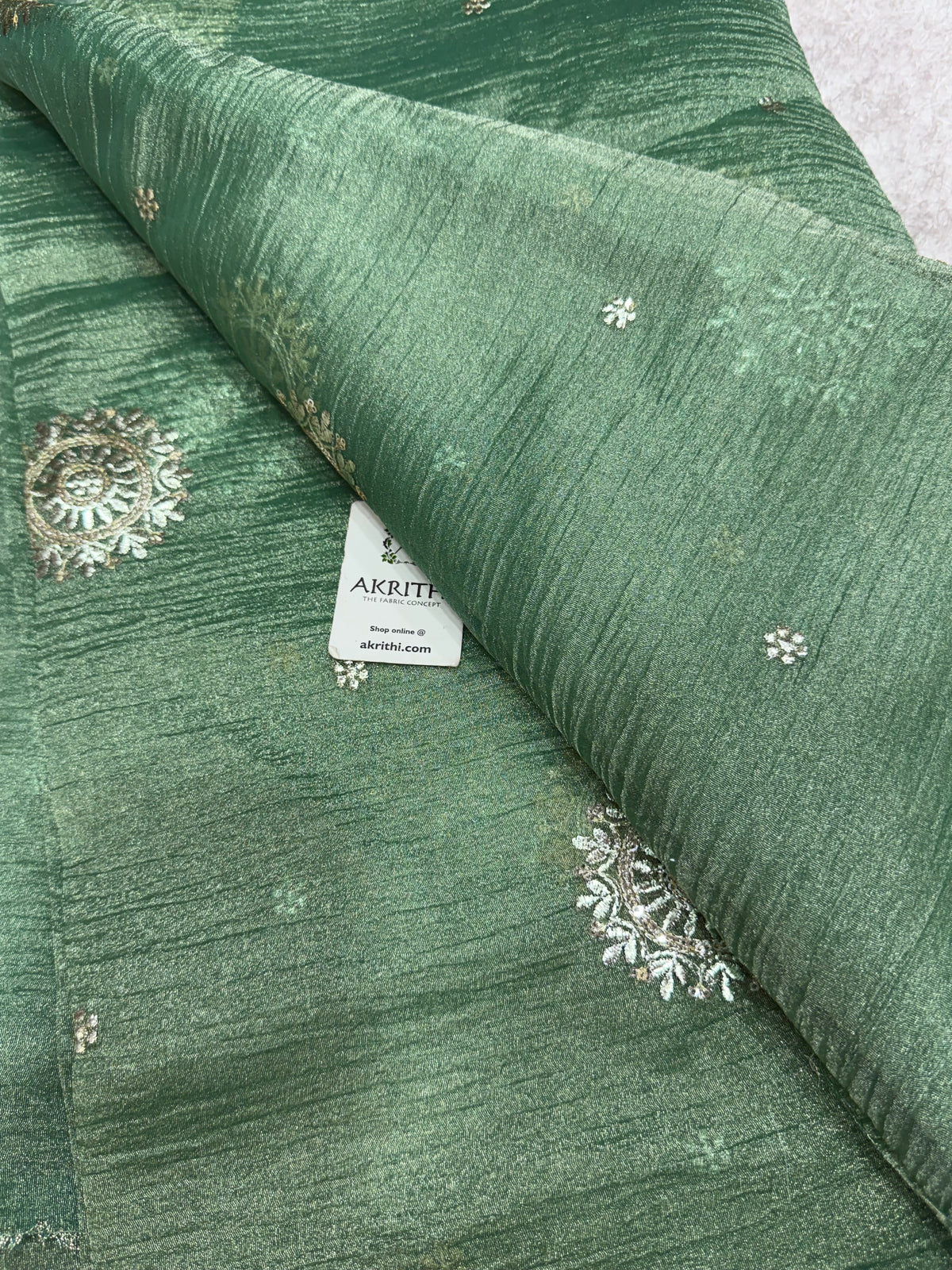 Embroidered crushed tissue fabric