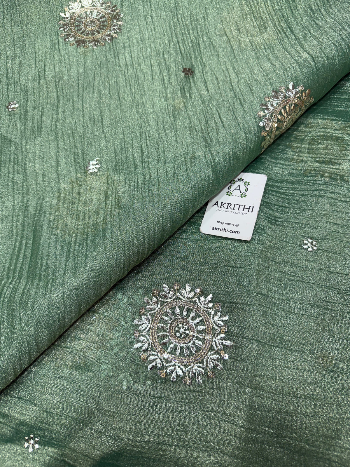 Embroidered crushed tissue fabric