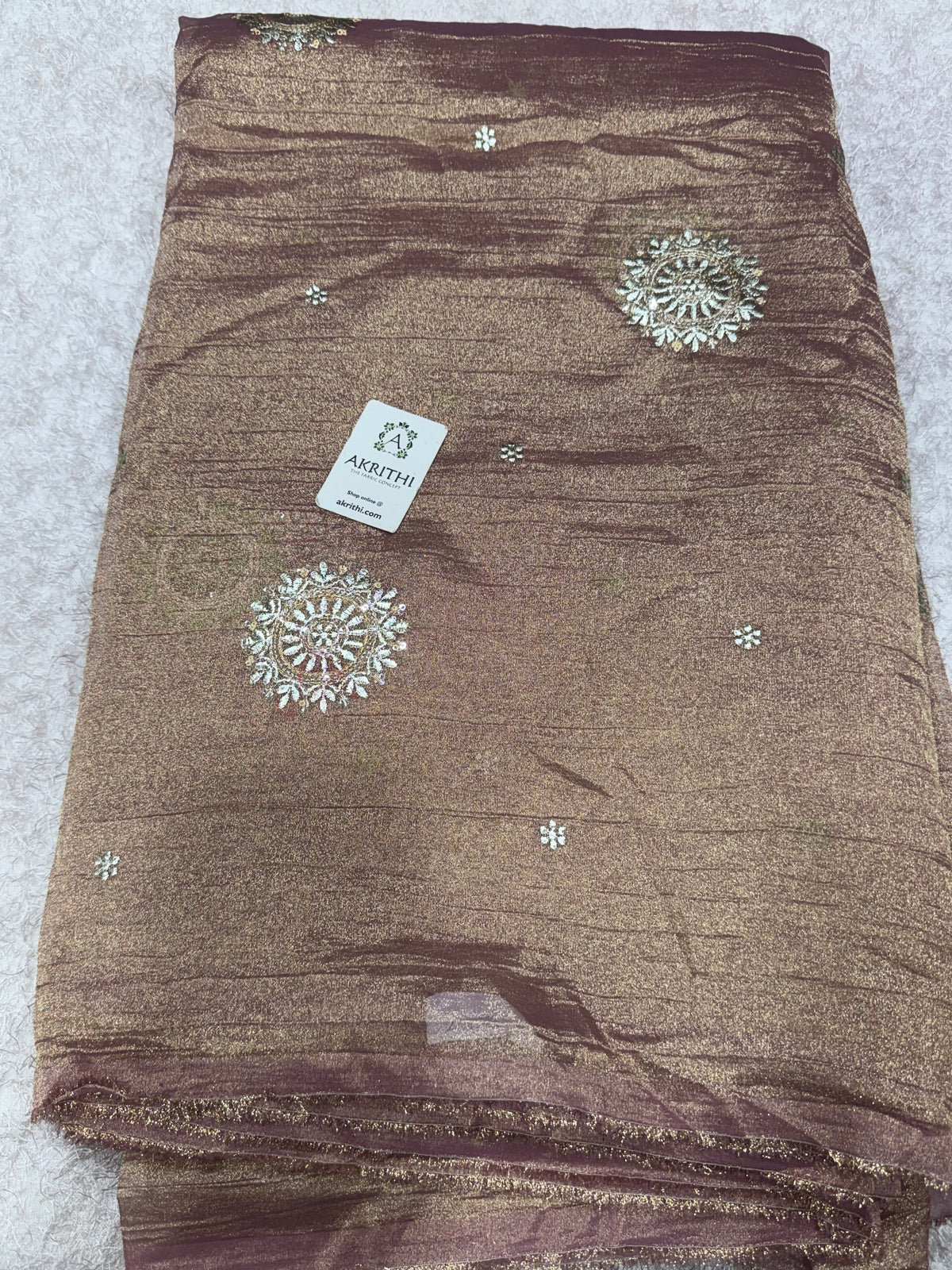 Embroidered crushed tissue fabric
