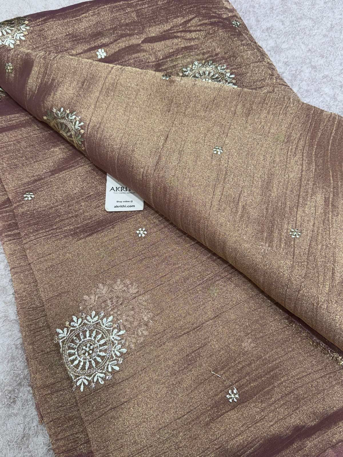 Embroidered crushed tissue fabric