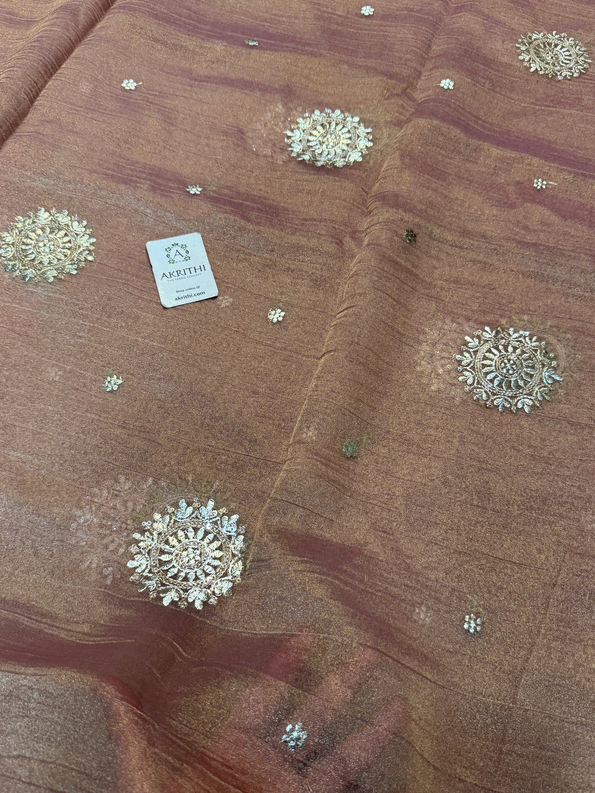 Embroidered crushed tissue fabric