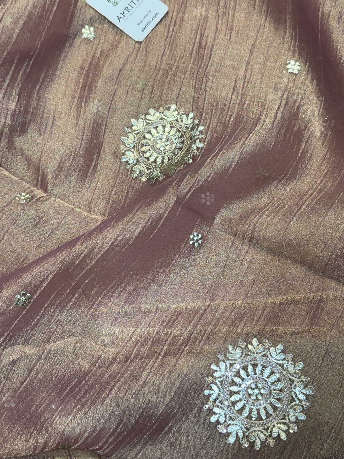 Embroidered crushed tissue fabric