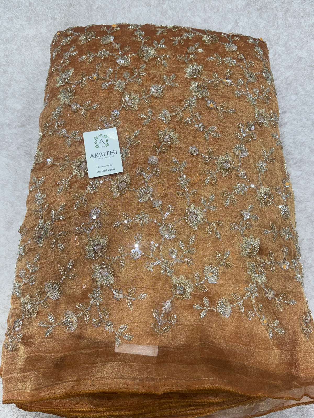 Embroidered crushed tissue fabric