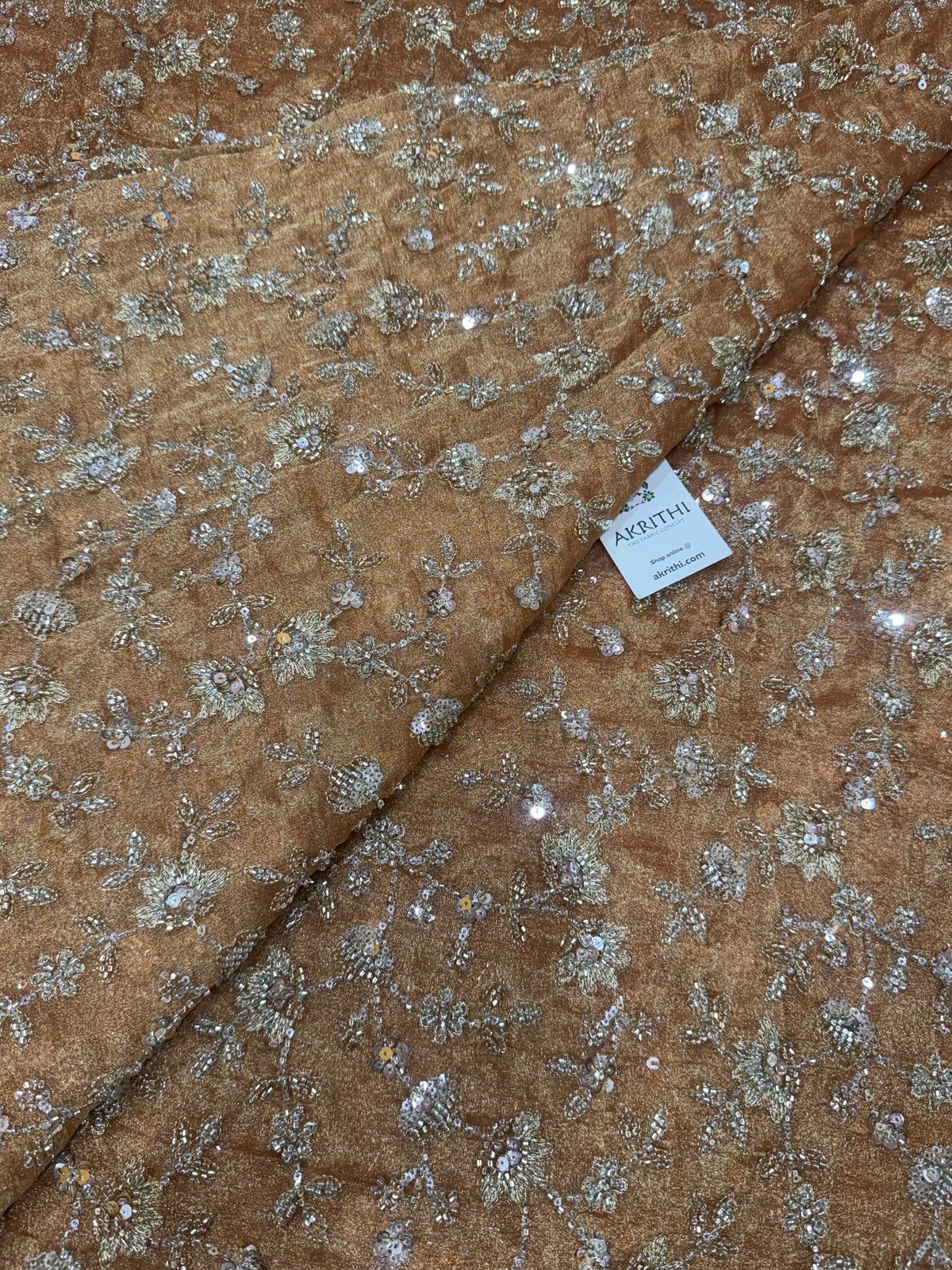 Embroidered crushed tissue fabric
