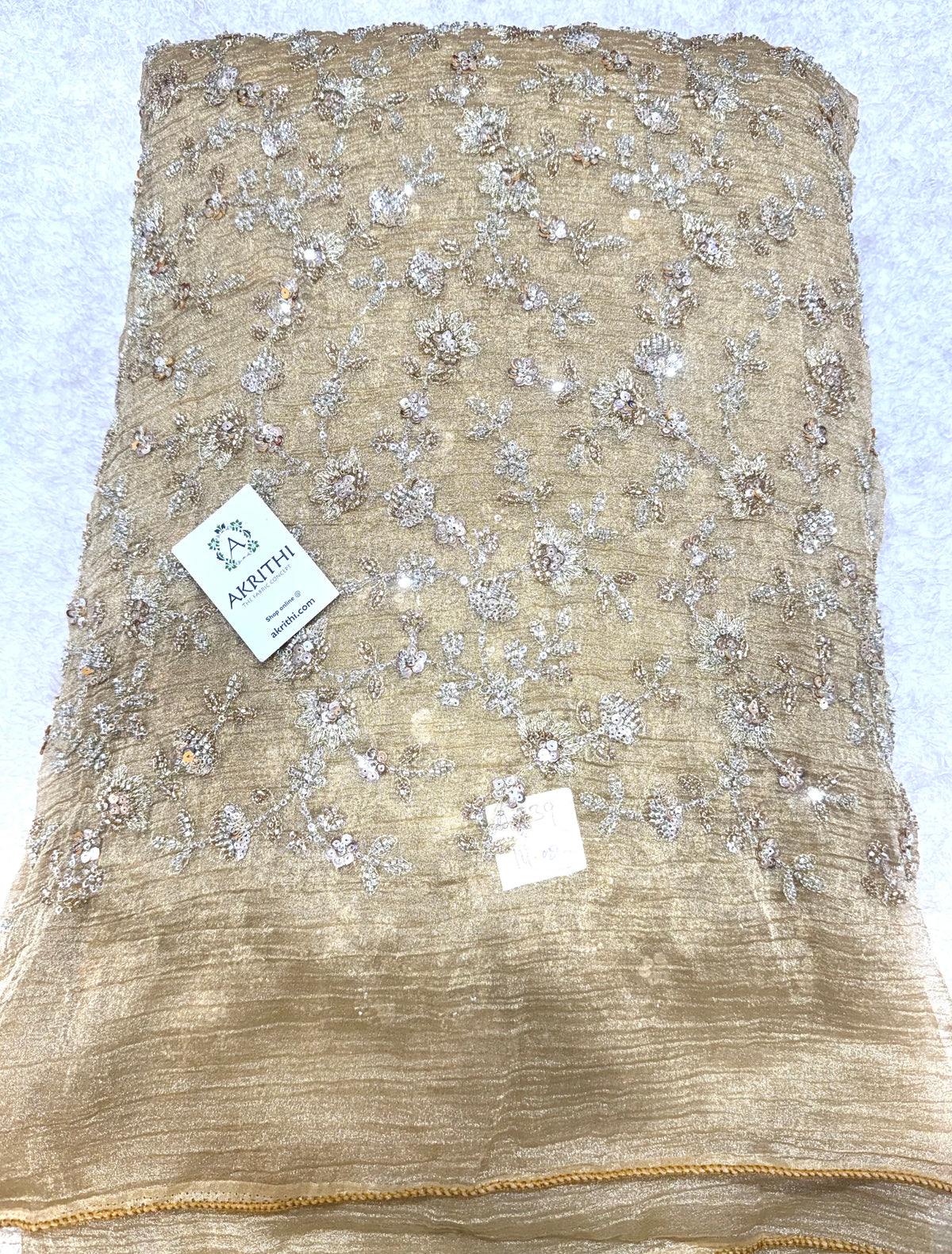 Embroidered crushed tissue fabric