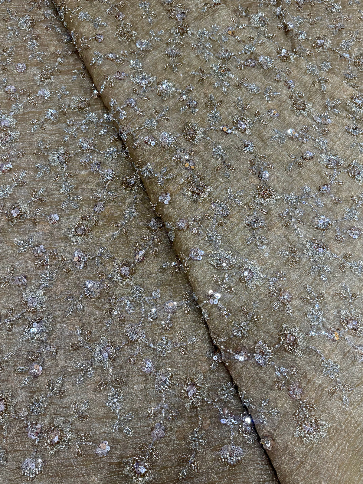 Embroidered crushed tissue fabric