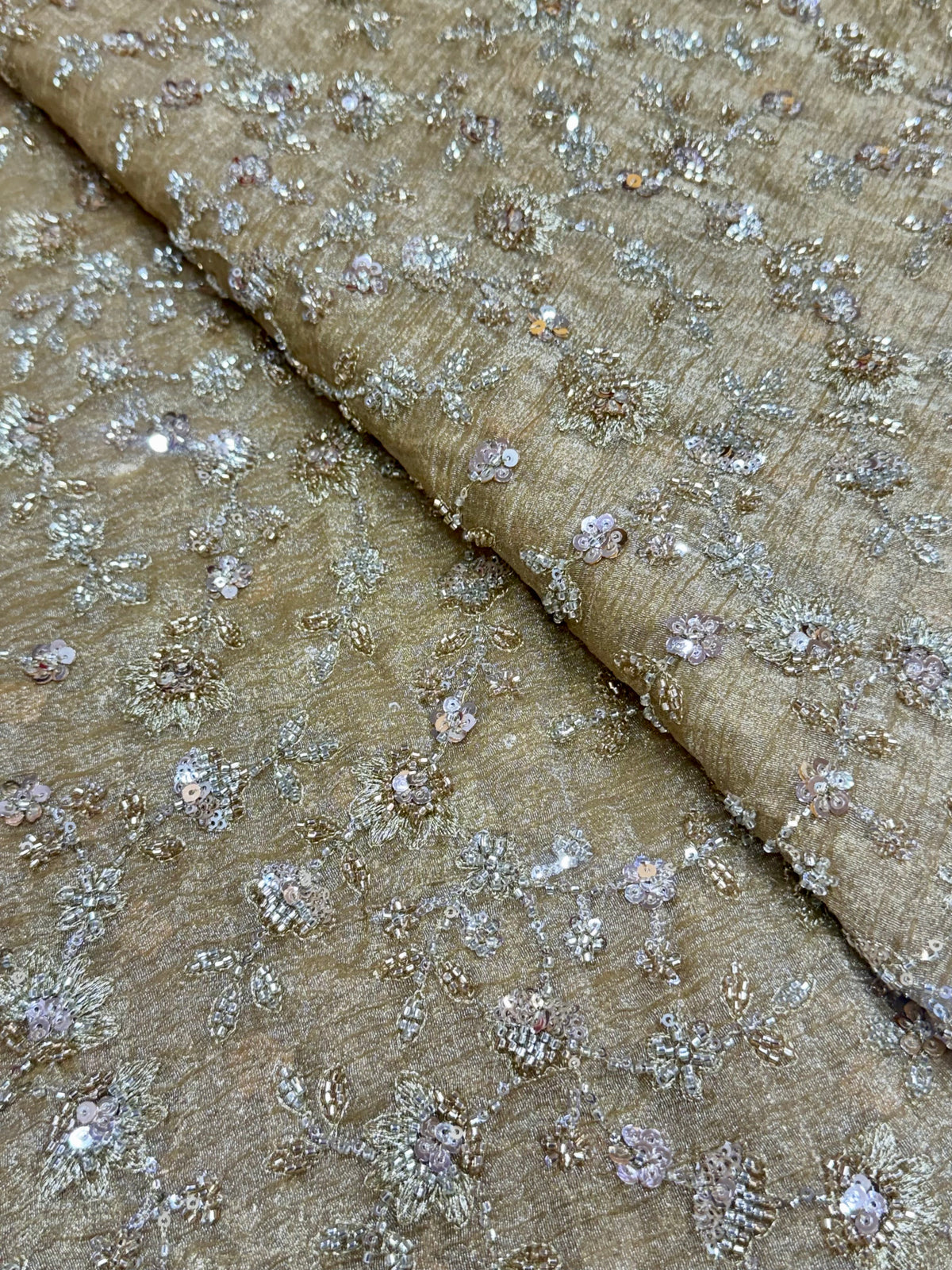 Embroidered crushed tissue fabric