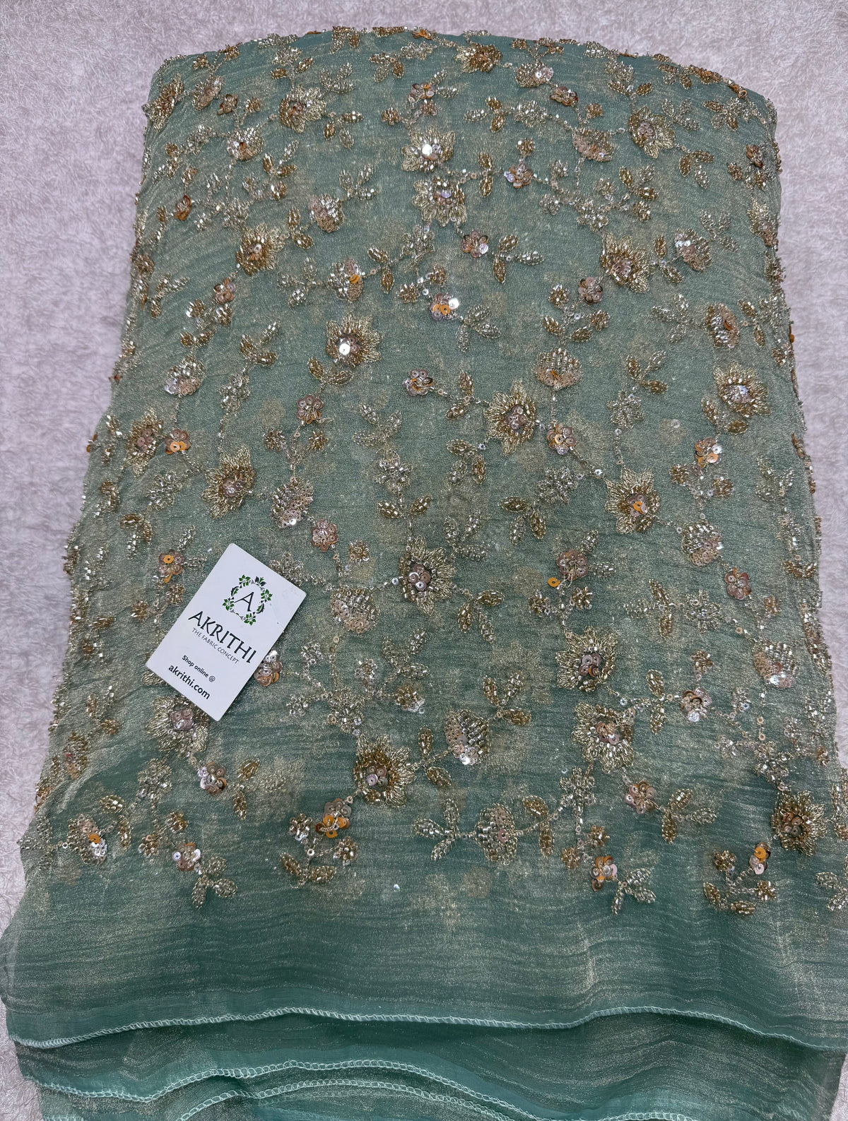 Embroidered crushed tissue fabric