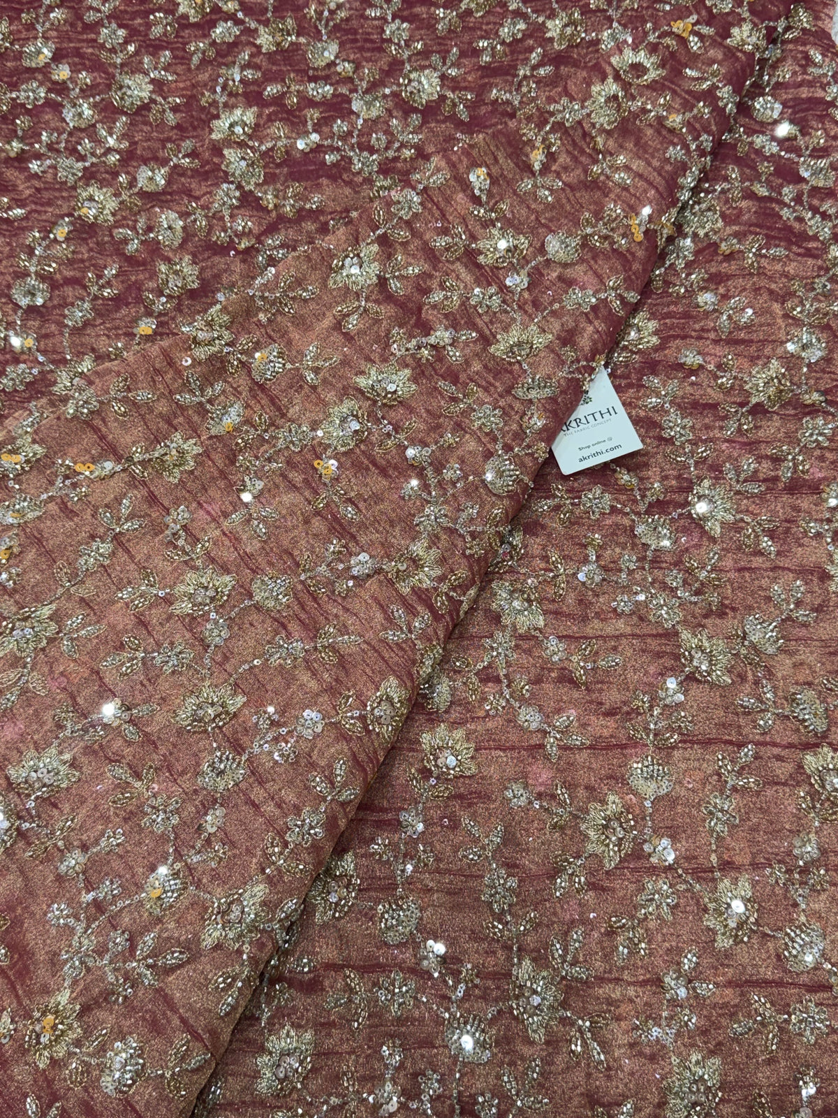 Embroidered crushed tissue fabric