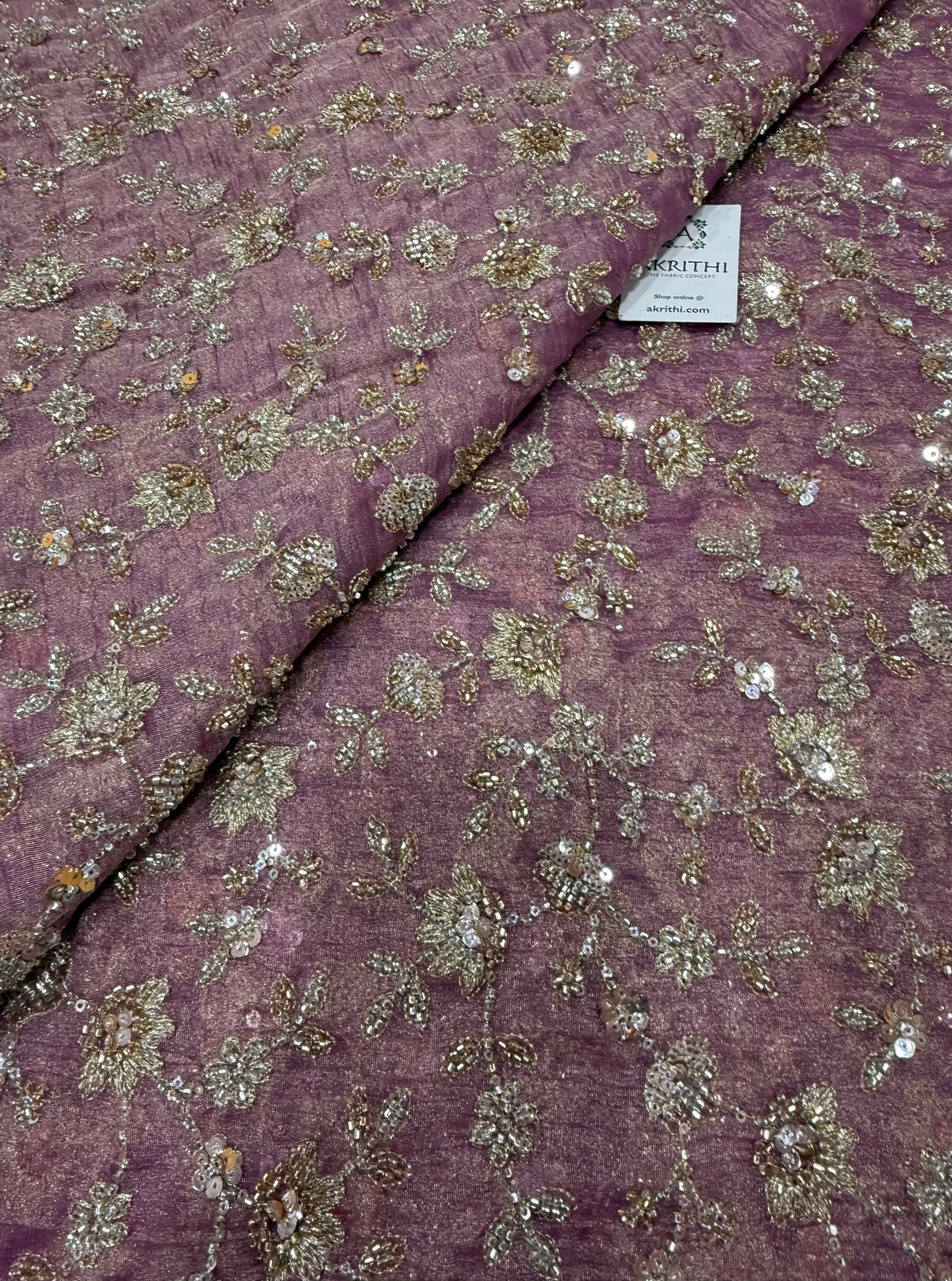 Embroidered crushed tissue fabric