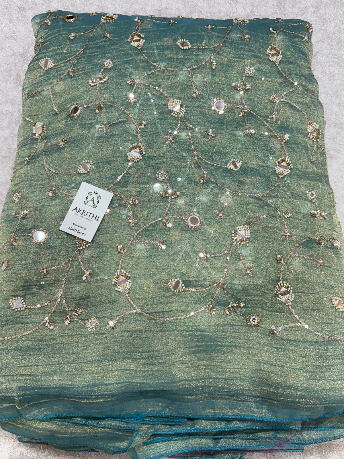 Embroidered crushed tissue fabric