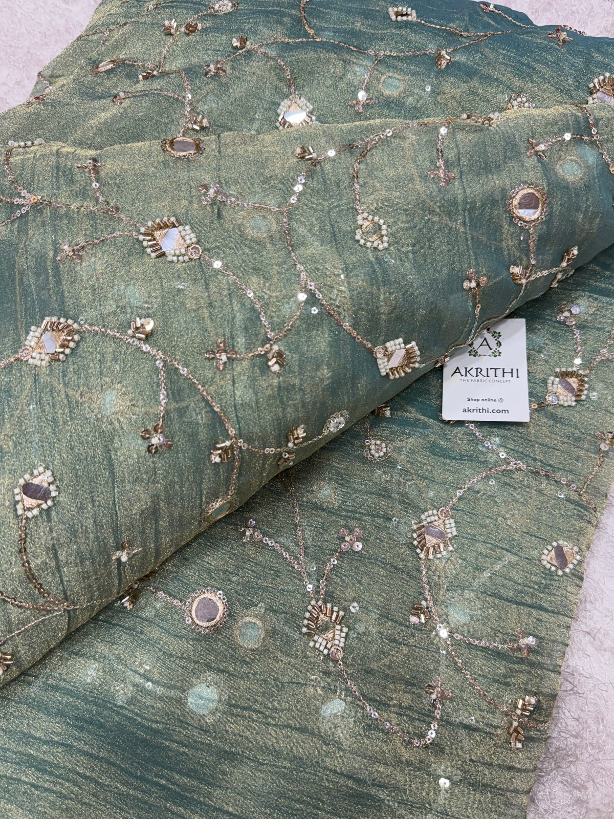 Embroidered crushed tissue fabric