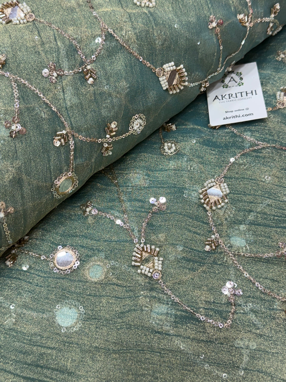 Embroidered crushed tissue fabric
