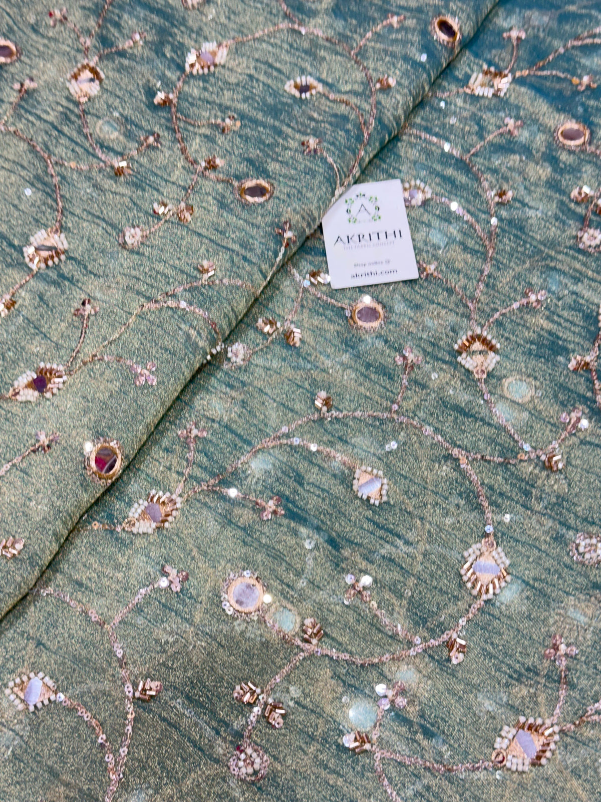 Embroidered crushed tissue fabric