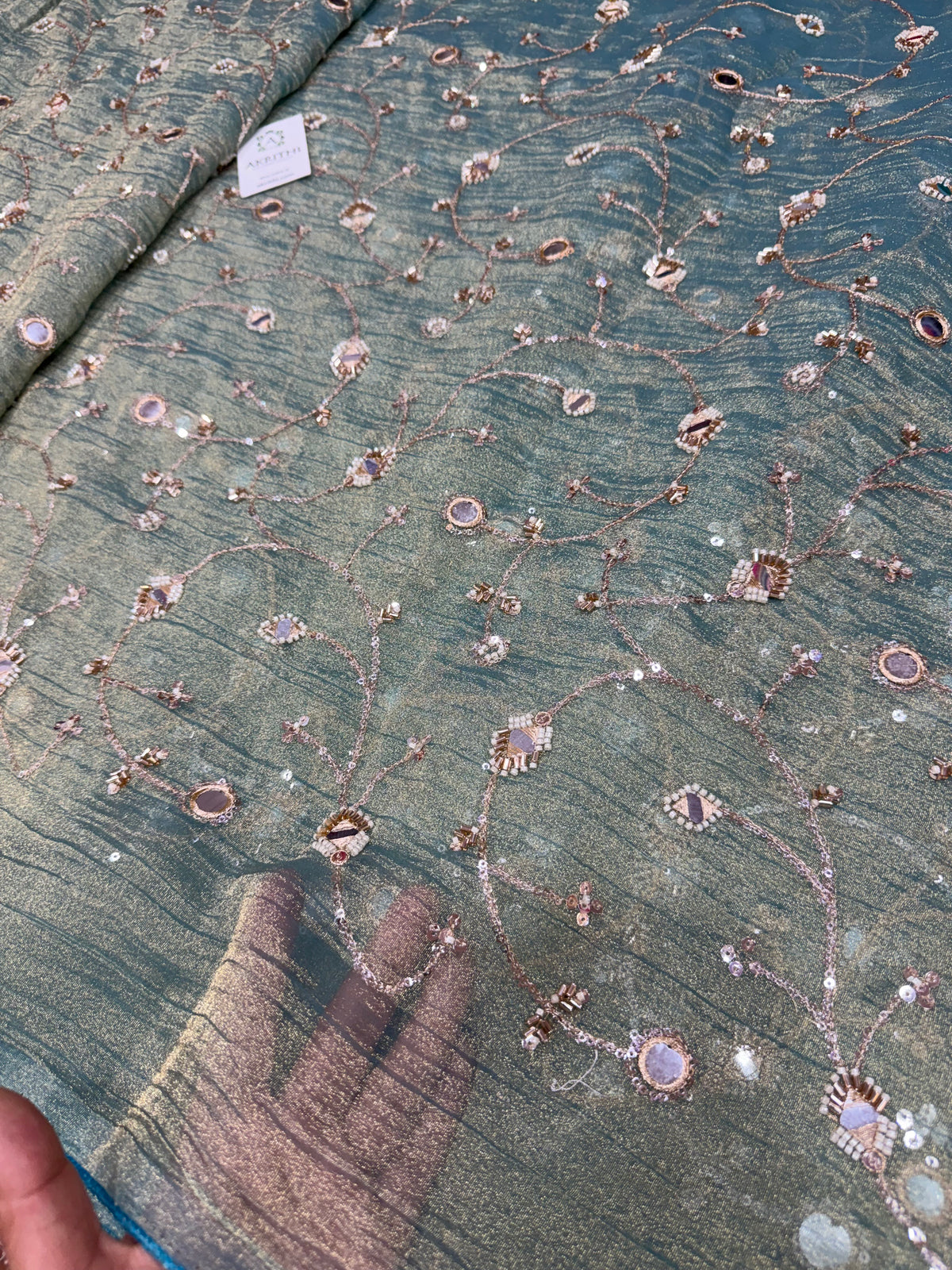 Embroidered crushed tissue fabric