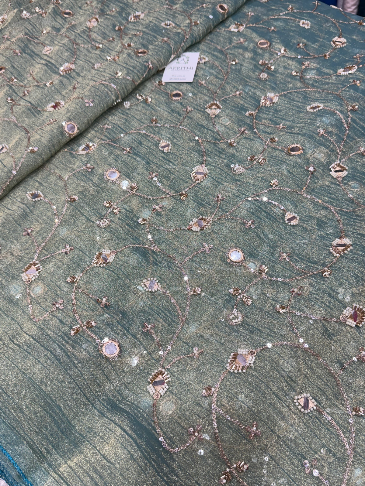 Embroidered crushed tissue fabric