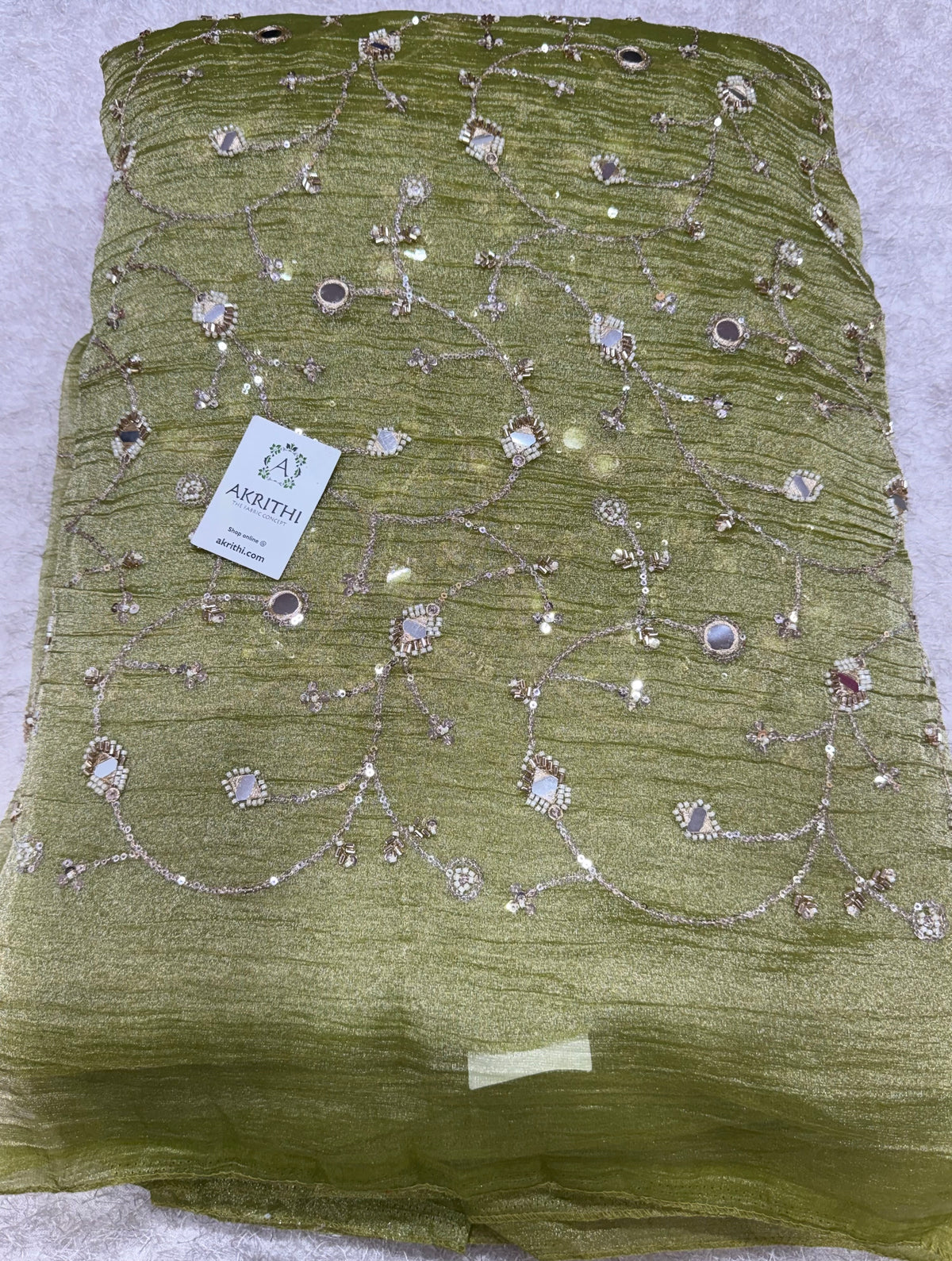 Embroidered crushed tissue fabric