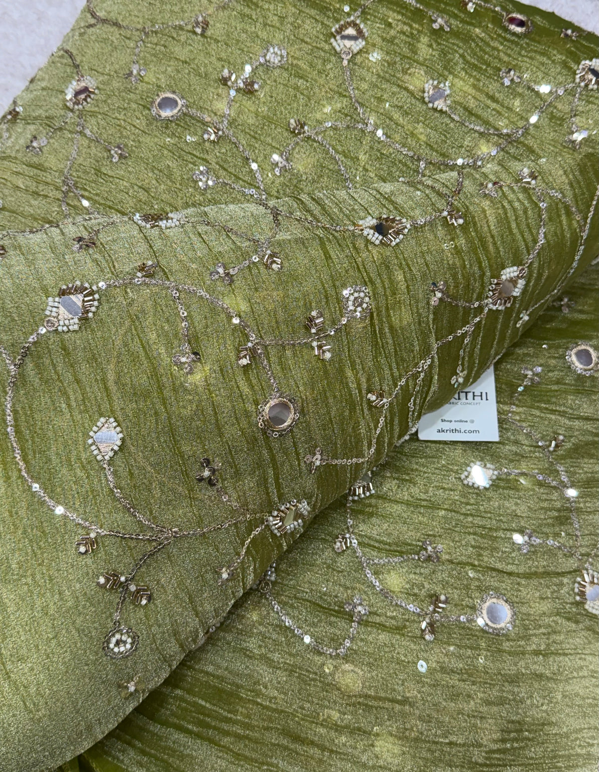 Embroidered crushed tissue fabric
