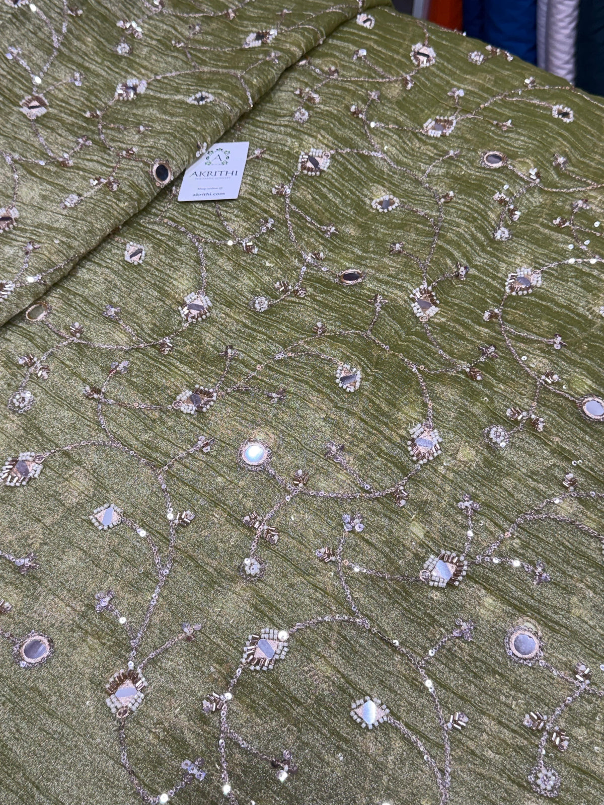 Embroidered crushed tissue fabric