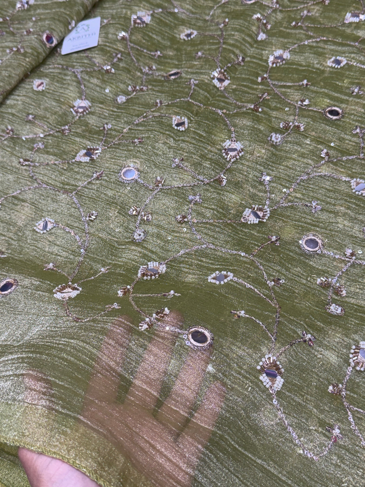 Embroidered crushed tissue fabric