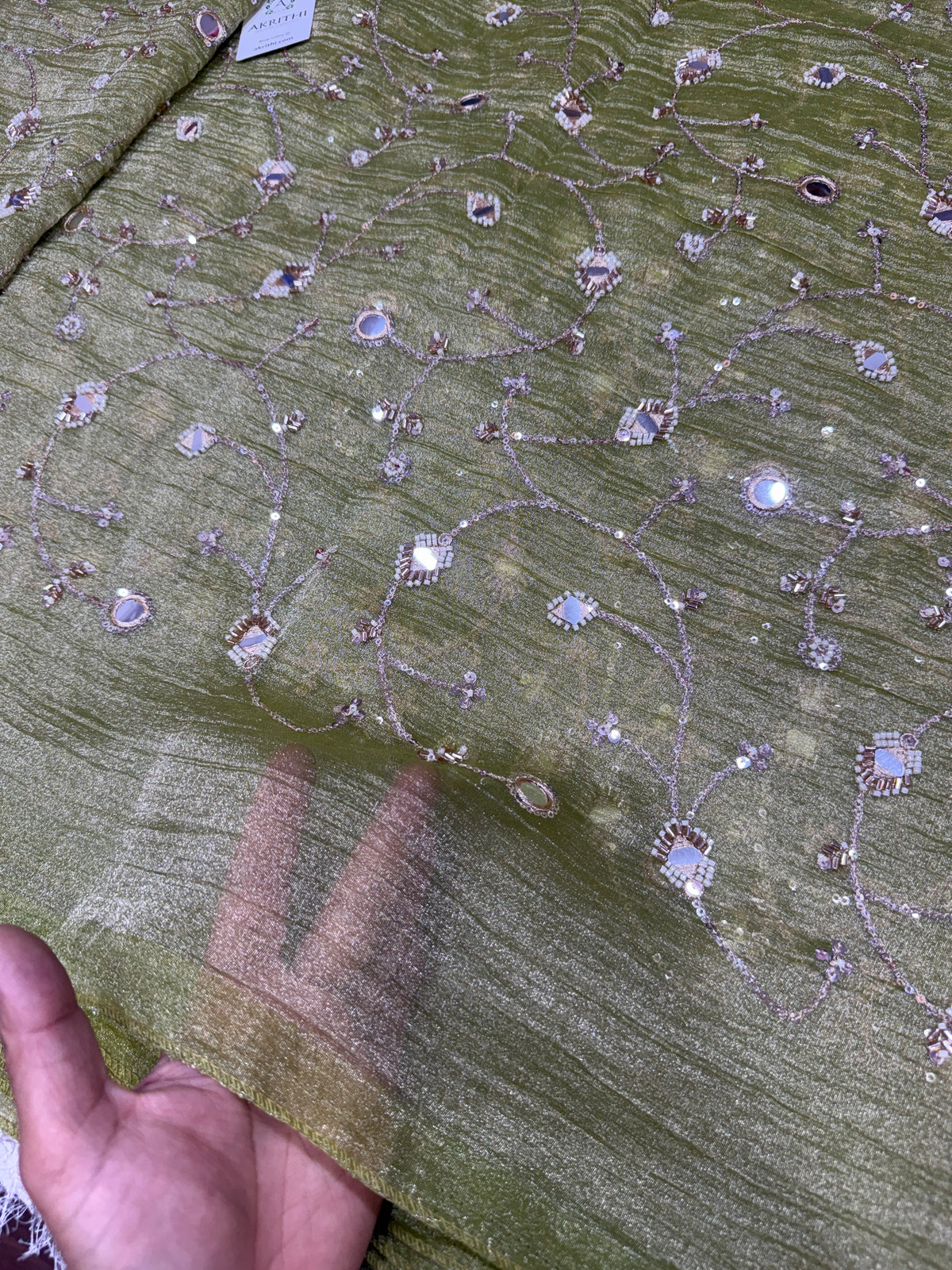 Embroidered crushed tissue fabric