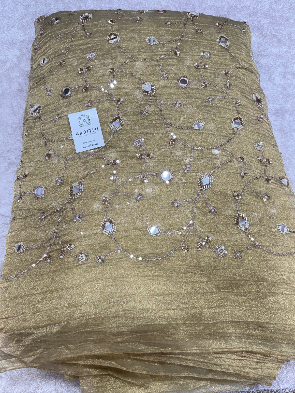 Embroidered crushed tissue fabric