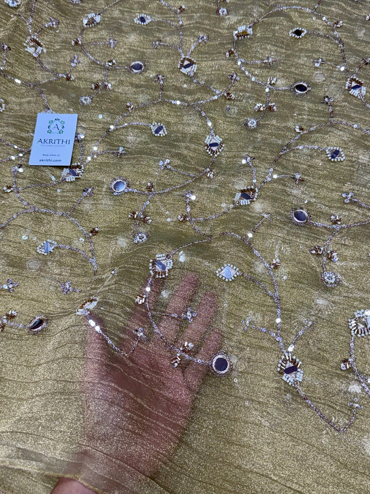 Embroidered crushed tissue fabric