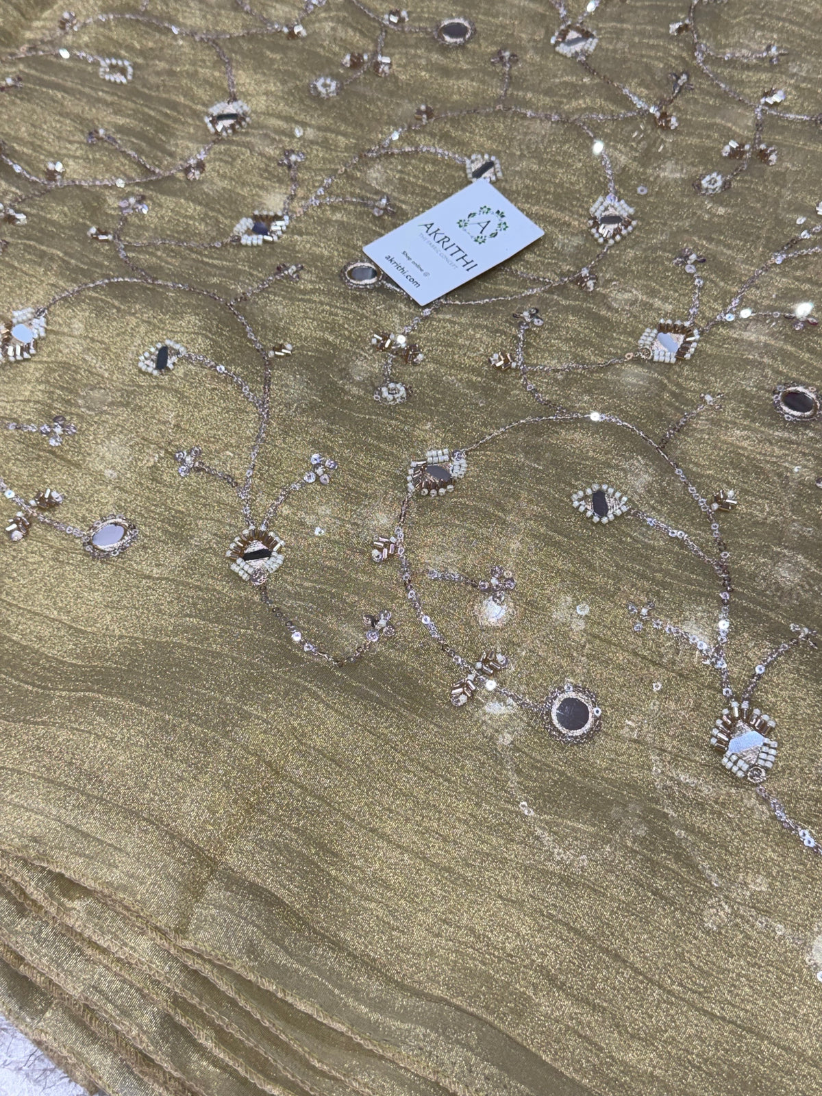Embroidered crushed tissue fabric