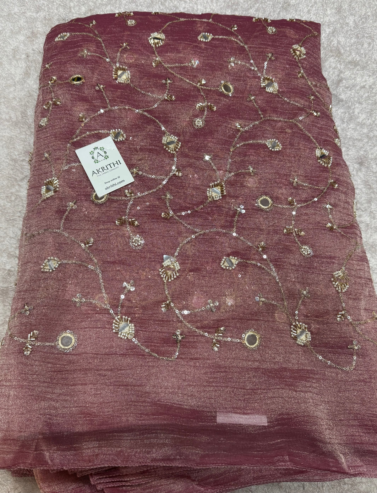 Embroidered crushed tissue fabric