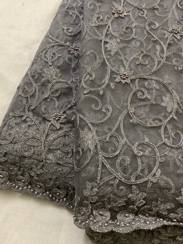 Embroidery on charcoal grey net fabric