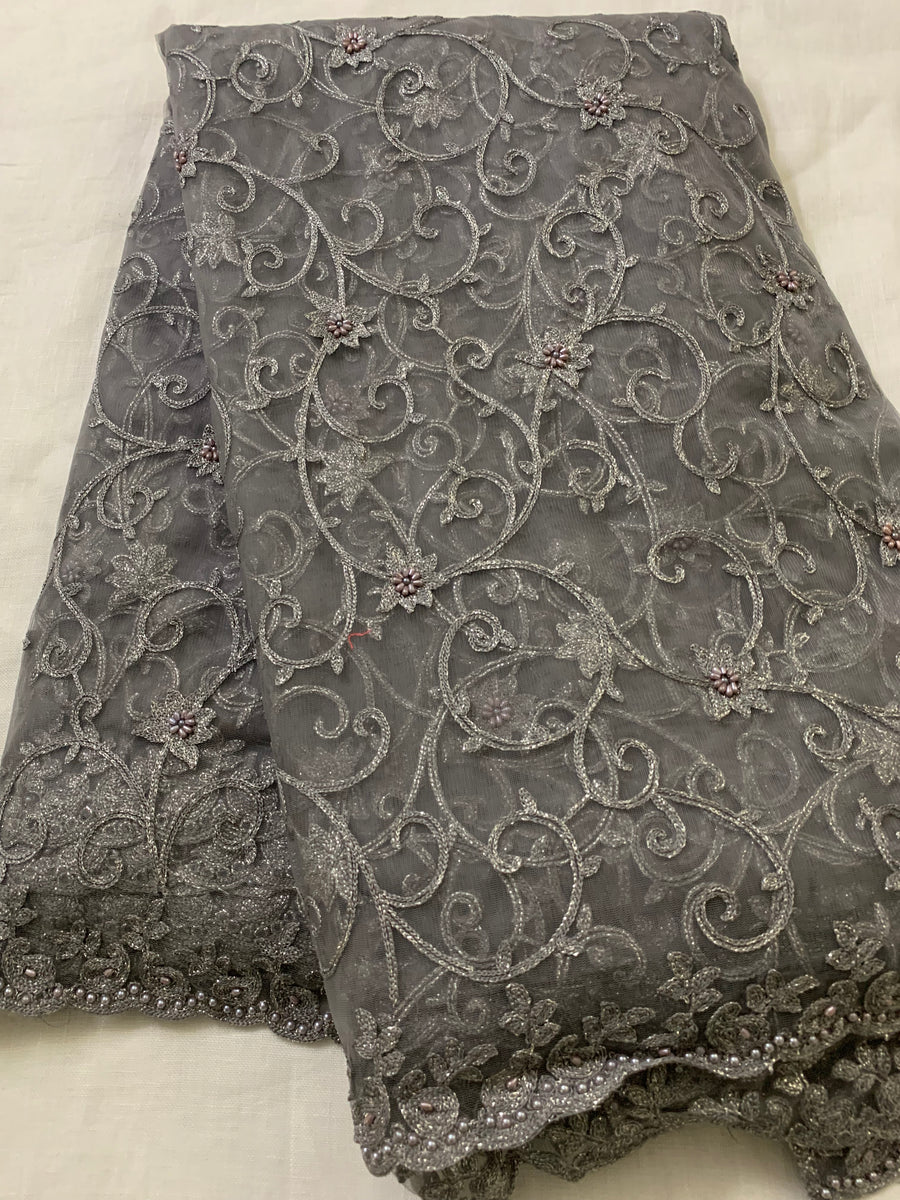Embroidery on charcoal grey net fabric